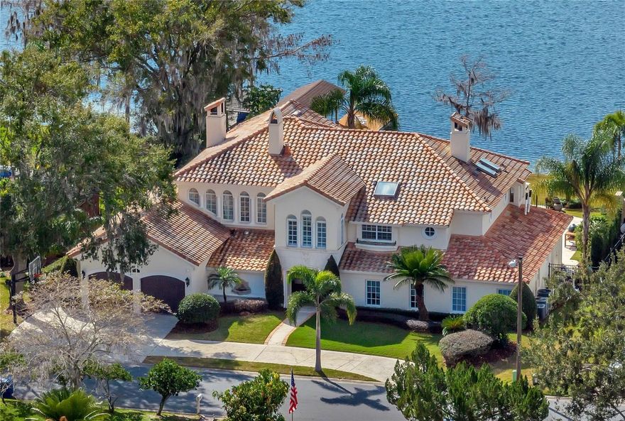 One or more photo(s) has been virtually staged. Lakefront luxury on the beautiful shores of Lake Killarney! Custom built with attention paid to every detail, this Mediterranean oasis delivers 4 spacious bedrooms, 3 full and 1 half baths, a library, theater room, climate controlled wine room, infinity edge pool and sweeping water views! 100’ of private lake frontage, 4 fireplaces, fiber optic lighting and a full Summer kitchen make this home an entertainer’s paradise. Step inside the grand front entry doors and be greeted by a panoramic view of Lake Killarney through the floor to ceiling windows. The custom 20’ stone fireplace is a striking feature of this open floor plan in addition to the travertine tile floors, and elegant floating staircase. Follow the natural flow into a chef’s dream kitchen featuring a hidden sub-zero refrigerator, Wolf gas range in the cooking island with granite counters throughout, and a comfortable casual breakfast nook with French door access outside and tons of natural light. The 3-sided stacked stone fireplace adds ambiance to the kitchen as well as a gorgeous custom-built library, and the beautiful living area, where 2-story windows complete with remote-controlled window treatments overlook Lake Killarney. The main floor features the 3 guest bedrooms, one with an en-suite bathroom. The staircase is a work of art and brings you to your personal retreat in the Owner’s suite, which features stunning lake views, a dual sided fireplace, sitting area, mini bar, oversized walk-in closet and a large private balcony! The en-suite bath features an expansive dual sink vanity for space and storage, jetted tub with lake views and a huge shower with dual shower heads and seamless glass doors. Also on the second floor is a bonus room which would make a great nursery, home office or gym, as well as a fully equipped and furnished media room. The backyard of this home is thoughtfully designed and one of a kind for the family that likes to entertain, offering a well equipped Summer kitchen with bar seating, fireplace, and a heated infinity pool with a zero edge spillover spa, colored lighting, and fire bowls. Bring your boat - the covered dock features a lift with electrical and a deck for watching the sunset over the lake! Call today and schedule your private tour of this lakefront sanctuary!