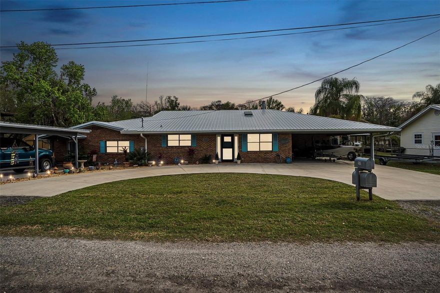 Discover this idyllic haven for water and boat enthusiasts nestled in the heart of Astor. This exquisite 4-bedroom, 2.5-bathroom single-family residence is the epitome of riverside charm, offering a lifestyle of aquatic bliss and comfort.

A unique highlight of the property is the opportunity for a separate apartment space—perfect as a private mother-in-law suite or an income-producing Airbnb rental. Whether you're looking to host extended family or generate additional revenue, this versatile area offers endless possibilities.

From the moment you step inside, you're greeted by an atmosphere of light and elegance, with wood look tile flooring that sweeps throughout the entire home. The stunning kitchen, boasting quartz countertops, a sleek island, and top-of-the-line stainless steel appliances, is sure to inspire culinary creativity and become the heart of the home.

The spacious primary suite is a serene retreat, with an updated bathroom that offers a touch of luxury to your daily routine. Each of the additional bedrooms provides ample space and tranquility, perfect for family or guests.

The showstopper is the beautiful sunroom, with its panoramic views of the water, inviting you to relax and soak in the scenic surroundings. Outside, the property further enchants with a boat house and a private dock on the canal, your gateway to the vast and vibrant St. Johns River. Whether you're a boating aficionado or simply cherish the peacefulness of waterside living, this is where your dreams become reality.

Upgraded lighting fixtures and bathrooms with refined finishes add to the modern allure of this waterfront gem. This aquatic lovers' gem is more than a home; it's a celebration of the water lover's lifestyle. Don't miss the opportunity to make it your own personal paradise.