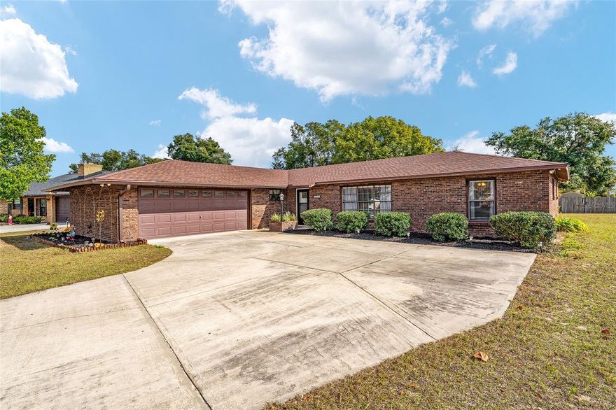 Welcome home to this timeless and cozy brick residence offering 3 bedrooms, 2 bathrooms, and a 2-car garage - all with no HOA! Ideally located just a few blocks from Lake Griffin State Park and access to the Harris Chain of Lakes, this home combines natural living and everyday convenience. Set on one of the largest fenced lots in the neighborhood (.37 acres), the outdoor space is truly special - perfect for gardening, enjoying your planted fruit trees, hosting outdoor barbecues, or tackling projects with the included shed. The screened back porch, complete with a new outdoor sink, creates the perfect spot to relax and unwind. Inside, the kitchen features stainless steel appliances and an eat-in peninsula, with generous living/dining spaces. The 3 bedrooms - the private primary wing with ensuite and walk-in closet, and the 2 cozy guest bedrooms with large closets - feature newer carpet and offer a peaceful retreat from your day. Inside and out, this home has been thoughtfully maintained and updated with a new roof and gutters (2023), newer hot water heater (2019), fresh paint, updated bathroom vanities, new front and exterior doors (2025), and more. These improvements make for a low-maintenance lifestyle from day one. Conveniently located minutes from shopping, dining, and everyday amenities in Fruitland Park, Leesburg, and The Villages, this move-in-ready home is ideal for buyers seeking comfort, space, and embracing the friendly Florida lifestyle. Schedule your private showing and discover all this charming home has to offer!