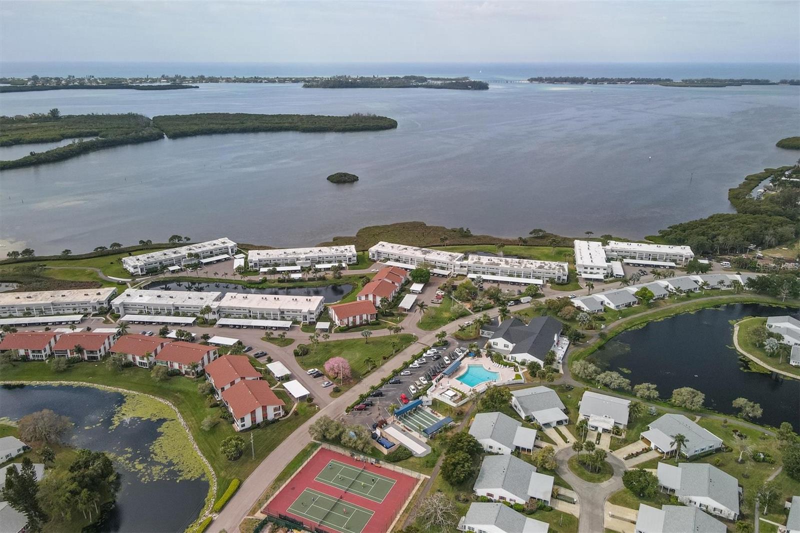 SARASOTA BAY VIEWS- Welcome to your immaculate retreat in the distinguished Mt. Vernon community of Bradenton. This stunning condo has
undergone a complete transformation, remodeled to perfection, and has since been meticulously maintained as a seasonal home by the owners,
with no rentals. Every detail of this residence has been thoughtfully upgraded to provide a luxurious and modern living experience. Upon entry,
you're greeted by the spacious living areas accentuated by raised ceilings throughout the unit, now soaring at 8 feet with no soffits in sight. The
outdated popcorn ceilings have been replaced with a sleek skip trowel finish, illuminated by modern canned ceiling lighting equipped with
dimmer switches. Crown molding adorns the entryway, dining room, living room, and main bedroom, while the batten board accented entry
hallway adds a touch of elegance. The remodeling spared no expense, with all-new interior doors and baseboard molding seamlessly blending
with the light and bright waterproof luxury vinyl flooring that graces every corner. In the gourmet kitchen, custom shaker cabinets provide ample
storage, complemented by a built-in pantry with roller drawers, roll-out trash and recycle bins, under cabinet lighting, and soft-close
drawers/doors. The granite countertops and breakfast bar provide both style and functionality, enhanced by stainless-steel appliances including a
refrigerator, oven, dishwasher, and microwave. A deep double bowl stainless steel sink with a garbage disposal and under sink water filtration
system make kitchen tasks a breeze. For added convenience, a contemporary stacked GE washer and dryer have been discreetly integrated into
the unit. The new A/C unit with UV light installed in June 2021 ensures year-round comfort, controlled effortlessly via the Nest programmable
and Wi-Fi accessible thermostat. Both bathrooms feature new tile finishes with built-in shelving, while the main bedroom boasts a double-tiered
shelving system in the closet for additional storage. You'll appreciate the sleek, modern ceiling fans with LED lighting in each bedroom, living
room, and lanai. The accessible and fully insulated attic above the living space and lanai further enhance energy efficiency. Tinted westerly facing
windows provide both privacy and energy savings. Outside, a covered assigned carport space with a storage locker awaits, providing
convenience and security. And for those moments of relaxation, blinds, shades, and curtains adorn every window, allowing you to effortlessly
control the ambiance of your serene oasis. Don't miss this rare opportunity to own one of the few Sarasota Bay view properties in the sought-
after Mt. Vernon community, offering resort-style amenities, RV storage, a kayak launch, and boat slips. A prime location near beaches,
shopping, and dining. Schedule your showing today and make this your new home sweet home!