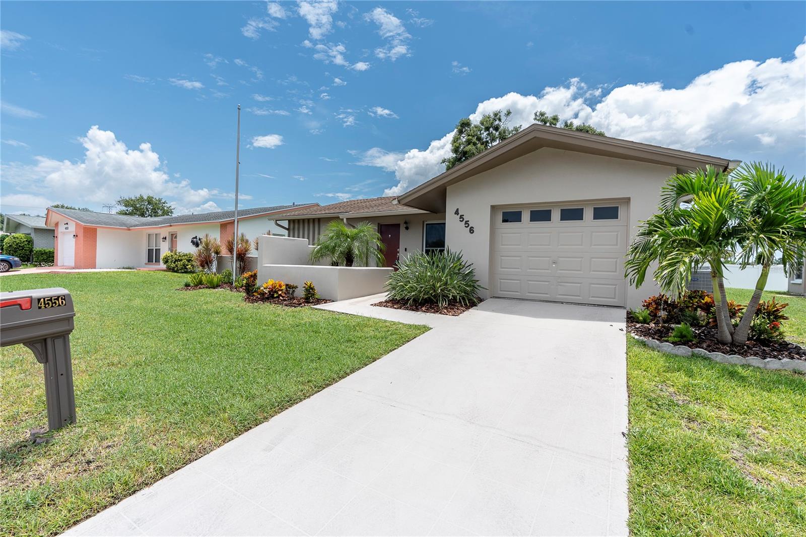 One or more photo(s) has been virtually staged. High & Dry! Hurricane-Resilient Home with Timeless Style and Modern Comforts. Proudly standing strong through Hurricane Helene and Milton, this solidly built home is located in a non-flood zone and has been lovingly maintained by the original owners since 1974. LARGER THAN MOST HOMES IN THE LAKES 55+ COMMUNITY! Offering 1,859 heated square feet of stylish and flexible living space, this 2-bedroom, 2-bathroom + OFFICE/DEN residence includes a 1-car garage and is move-in ready. Step inside to discover a light-filled formal living area with flexible spaces perfect for dining, relaxing, or entertaining. French doors lead to a bright and airy family room featuring vaulted ceilings, creating an open and welcoming atmosphere. The thoughtfully designed kitchen is the heart of the home, boasting Corian countertops, a tile backsplash, double oven, and ample cabinetry with a built-in pantry—perfect for those who love to cook or entertain. The versatile office/den offers direct access to the backyard and can easily serve as a third bedroom, home office, or creative space. The spacious primary suite is a true retreat with a large walk-in closet, additional wall closet, and a private en suite bathroom. Both full-size bathrooms are updated with easy-care glass shower doors. Notable upgrades include: Hurricane-rated windows; owned solar panels for the water heater; hurricane rated garage door; Hunter Douglas ceiling fans; backyard paver patio, and window treatments throughout. The family room and den/office addition was completed by a notable contractor and constructed using updated hurricane codes. Located in a well-kept community of The Lakes with aesthetically pleasing underground utilities and manicured landscaping. Affordable $280/month HOA fee cover: basic lawn care; reclaimed water for lawn irrigation; Spectrum high speed internet and cable; access to a newly remodeled clubhouse; heated pool; shuffleboard courts; billiards; cards room; and library. Ideally situated near parks, restaurants, and shopping, and just 30 minutes to the beach. Quick access to Tampa International and Clearwater Airports makes travel a breeze. This home combines peace of mind, low-maintenance living, and unbeatable location—don’t miss your chance to make it yours!
