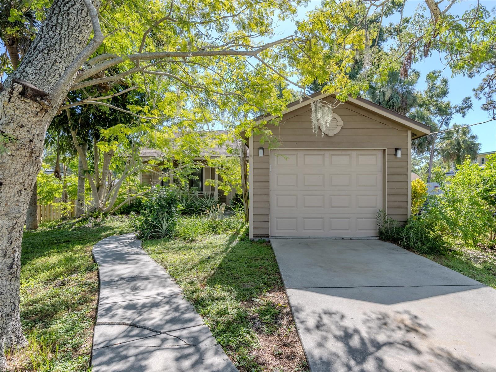 Unlock the possibilities in this 2-bedroom, 1-bathroom home located in desirable South Sarasota! Major expenses are already off your plate: the roof, AC, and garage door were updated in 2015, and hurricane-impact windows were added in 2017, along with overhead plumbing. Now, it's your turn to unleash your vision on the interior, which is perfectly poised for renovations ranging from a quick refresh to a full redesign. The garage, currently accommodating a small car due to a previous modification, offers the flexibility to be converted back to a standard single-car size. With its fantastic proximity to beaches, shopping, gyms, and schools, come see this gem while you have the chance!