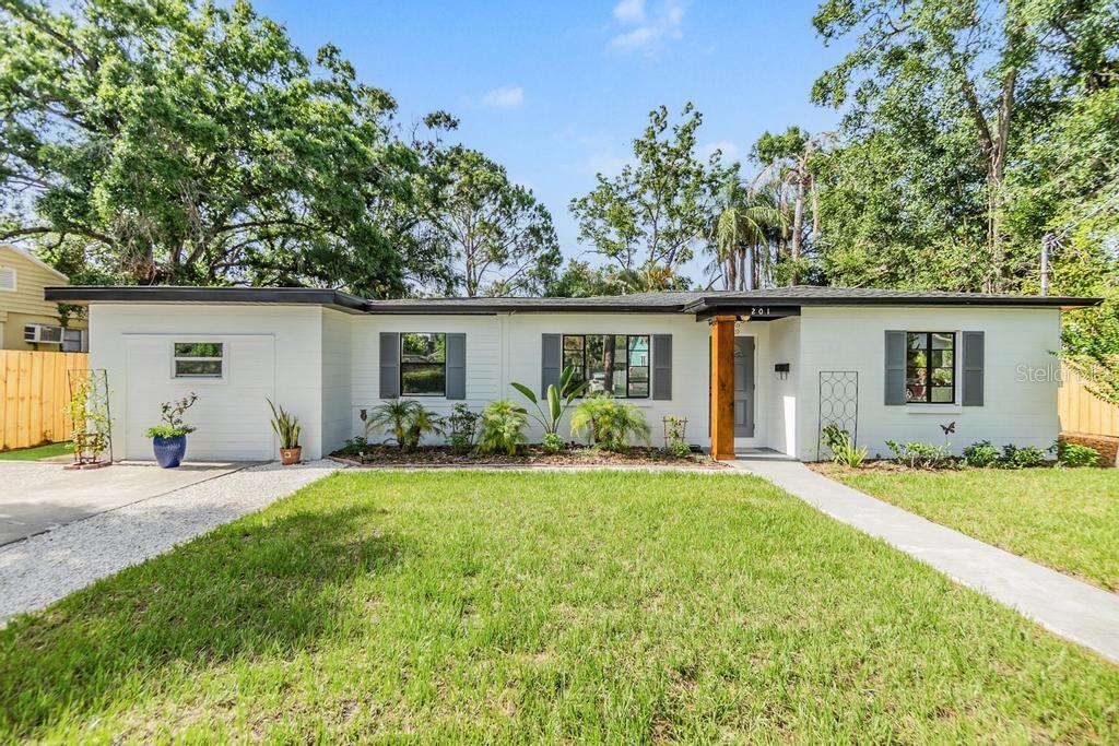 Welcome to this beautifully updated mid-century modern, single-story block ranch, perfectly situated on an expansive lot with backyard access. This home features 3 bedrooms, a den/office, a full bath and half bath and effortlessly blends timeless design with modern upgrades. Inside, you'll find tile floors throughout, sleek granite countertops, stainless steel appliances, and freshly painted interior and exterior. The bright, clean feel is complemented by brand-new bathroom vanities that add a touch of luxury. The primary bedroom has been upgraded with a brand new mini split A/C system to keep you cool and comfortable. The 130 sq ft utility room is airconditioned and is configured as a half bath. Step through the elegant French doors into your backyard oasis featuring approximately 1,000 square feet of low-maintenance artificial turf, new sod, a stylish sail shade for relaxing afternoons, and a brand-new 6-foot board-on-board wood fence for added privacy. Whether you're entertaining, relaxing, or planning future expansions, this property offers flexibility and style in equal measure. Amazing opportunity for those looking to enjoy "The Heights Life". The highly popular Seminole Heights neighborhood is surrounded by amazing retail, restaurants and recreation. Minutes to downtown Tampa, Armature Works, Tampa International Airport and International Plaza.