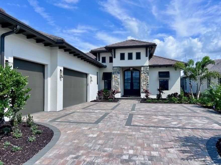 Pre-Construction. To be built. This magnificent home by Lee Wetherington is set to be constructed and completed by May 2026. Embrace a lifestyle of modern elegance and luxury in this exceptional 4-bedroom, 4-bath residence. Upon entering through the stylish modern front door, you'll be welcomed by impressive vaulted ceilings and an open-concept layout that merges spaciousness with sophistication. 

The centerpiece of this home is the stunning gourmet chef's kitchen, perfect for entertaining. It boasts custom modern wood cabinetry, luxury glass stainless steel appliances, and a remarkable oversized quartz island. Each generously sized bedroom offers a private sanctuary, complete with its own en-suite bathroom and designer finishes to ensure comfort and elegance. The master suite is a highlight, featuring a spa-inspired bathroom with a soaking tub, dual vanities, a walk-in rain shower, and custom-built walk-in closets to accommodate every need.

Outside, you'll find your own private tropical oasis. The tranquil backyard setting provides an ideal spot for relaxation and entertaining, with a serene pool deck, a gleaming heated pool and spa, and lush landscaping offering beauty and privacy. An outdoor entertainment area enhances the space, perfect for hosting gatherings.

Built with modern luxury in mind, this exquisite home includes impact glass windows, custom blinds, epoxy-finished garage floors, and high-quality materials throughout. It resides in a community of new multi-million-dollar homes, enhancing its exclusivity and prestige. Located just minutes from the lively downtown Sarasota and the pristine shores of the renowned Siesta Key Beach and Lido Beach, this property offers unmatched access to upscale shopping, fine dining, cultural venues, and recreational activities. Whether you seek an entertainer’s dream or a luxurious retreat, this home has it all. Experience the pinnacle of Florida living with this extraordinary residence.