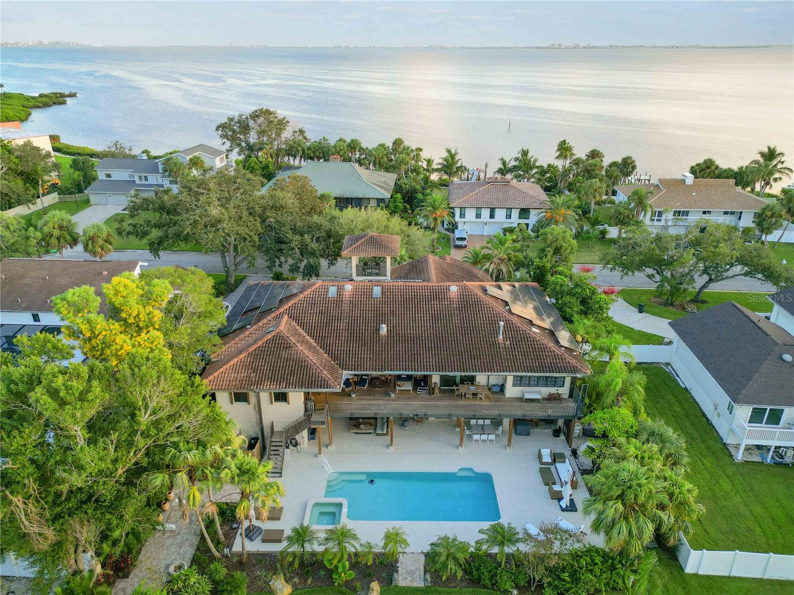 Discover your slice of paradise at this stunning waterfront home nestled in the serene community of El Conquistador Bayside. This rare expansive one acre lot has an exceptional outdoor living space that is perfect for entertaining and relaxation.
The fully-equipped kitchen is a chef's dream, complete with stainless steel appliances, granite countertops, and ample cabinet space, ideal for culinary creations. The property includes an elevator, Butlers pantry, mother in law suite on the lower level, beautiful views of the Gulf, a 4-car garage, five generously sized bedrooms, each providing a peaceful retreat with plenty of closet space and picturesque views. Step outside to your private backyard, where you can unwind on the patio or take a dip in the oversized sparkling pool or hot tub. The lush landscaping enhances the tranquil setting, making it perfect for outdoor events and family dinners. Situated just minutes from the beautiful beaches of Anna Maria Island and the vibrant downtown Bradenton, this home offers easy access to shopping, dining, and recreational activities. Perfect for families, this home is located three miles from the renowned IMG Academy, known for its elite sports training programs and academic excellence. Whether your child is pursuing athletics or academics, the proximity to this prestigious institution adds significant value. The home had zero water intrusion during last year's storms. This is a rare gem that truly stands out. Don’t miss your chance to make this waterfront haven your own! You must see it in person to appreciate the lot size and opportunities this home presents for growth and expansion. Schedule a showing today and experience the beauty of Florida living!