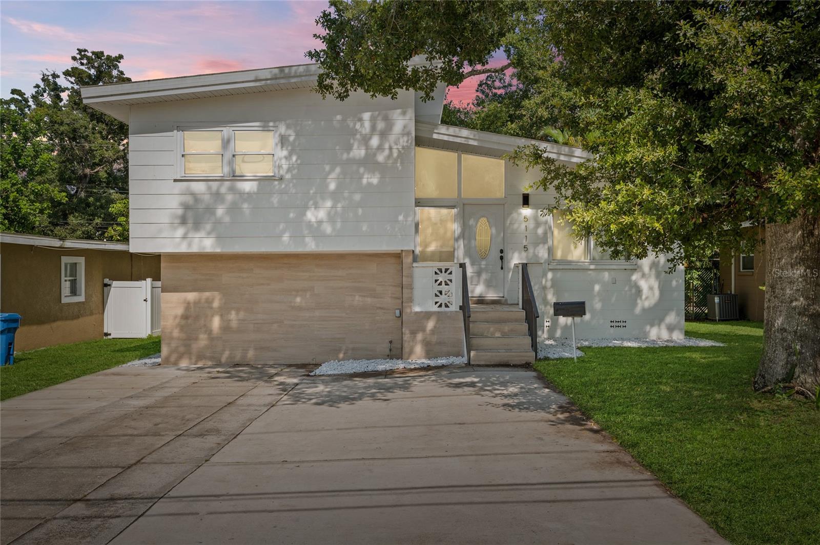 Exceptionally renovated 4 Bedroom 3 Bath move-in ready home in North St. Pete! With no HOA, no flood zone, and a deep 100ft lot, you have all the freedom you need to make it your own. Stepping into the living room you’ll love the soaring ceilings, beautiful marble-inspired tile, accent fireplace, and open floor plan. The kitchen features white shaker cabinets, stainless steel appliances, beautiful quartz countertops, and a large entertaining island for casual eating. Its ideal split floor plan has the master bedroom downstairs with its own massive en-suite bathroom and the three additional guest bedrooms and two guest bathrooms upstairs. All bathrooms have been consistently updated for an elevated modern aesthetic, while still maintaining charming character. The backyard has a new EXPANSIVE wooden deck with a custom built-in pergola, paver patio below, and green space for the little ones and pets. Additional upgrades include a 2022 AC and 2022 hot water heater. You will love living minutes to all that 4th St N has to offer in terms of your daily conveniences, restaurants, and shopping. Not to mention also being 8 minutes to downtown St. Pete, 24 minutes to the best beaches in the country, and only 16 minutes to Tampa International Airport! If you’ve been searching for that elusive 4 bedroom home that doesn’t need $100k to renovate it, do not miss out on this one!