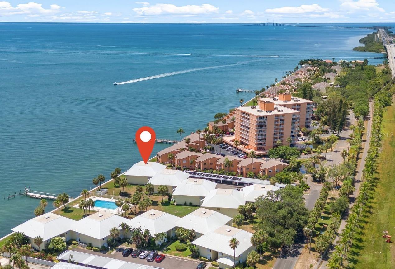 AMAZING Price for this beautiful waterfront condo. Unit had NO flooding or damage from 2024 storms. Welcome to Fabulous Florida Living at Hidden Bay Villas, a waterfront paradise in St. Petersburg! This Key West-style community of only 40 units offers breathtaking, unobstructed views of Tampa Bay and the Sunshine Skyway Bridge—you’ll wake up to stunning sunrises and daily dolphin sightings right outside your window. This impressive 2-bedroom, 2-bath condo boasts an open floor plan, a spacious primary suite with patio access, a walk-in closet, and an ensuite bath, plus a large guest room with its own private bathroom access. The well-appointed kitchen features solid wood cabinets, granite countertops, and stainless steel appliances, along with a versatile breakfast nook that can also serve as a home office space. Step onto your covered balcony for panoramic bay views, or take the private stairwell down to the waterfront. (Unit can be sold turnkey / furnished.) Hidden Bay Villas is pet-friendly, all-ages, and rental-friendly (30-day minimum, up to 3 times a year). The HOA covers flood insurance, cable, water, sewer, trash, and pool/grounds maintenance—offering a truly hassle-free lifestyle. Community amenities include a sparkling waterfront pool, a fishing pier, and lush tropical landscaping. Conveniently located near I-275, Maximo Park, O’Neills Marina, and Downtown St. Pete, with easy access to award-winning beaches, restaurants, festivals, and shopping. Plus, the brand-new SkyBar is just a block away! This is truly coastal living at its finest—don’t miss your chance to own this rare piece of paradise. Unit can be rented right away; no minimum years of ownership required. New Electric panel (2025). Schedule your showing today! * (All furntiure was sold in an estate sale and Condo is no longer furnished.)