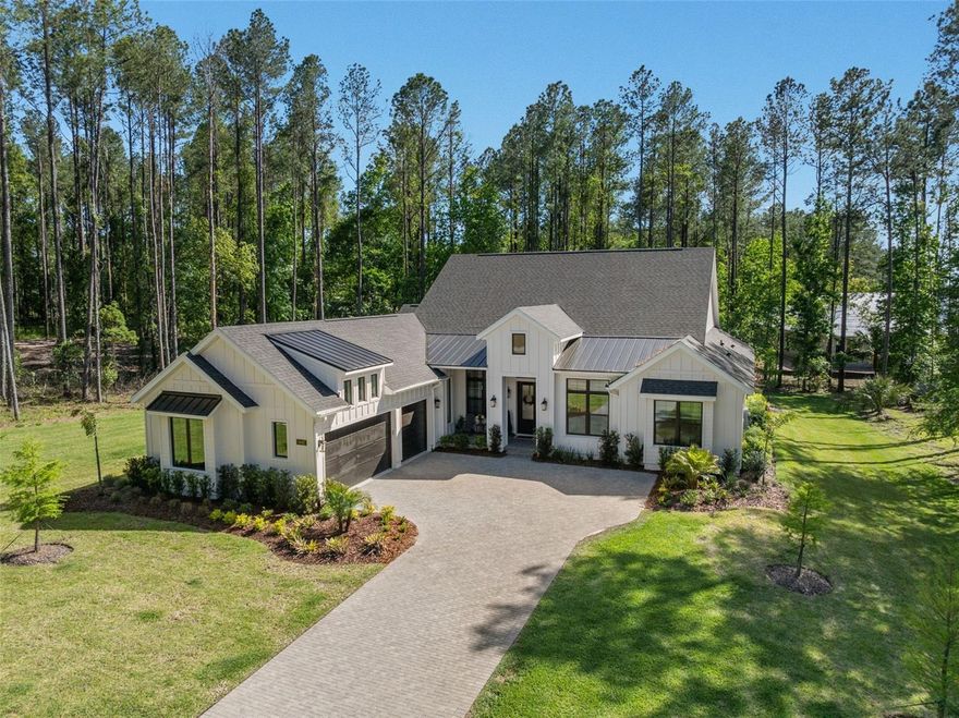 Nestled within the gated, resort-style community of Southern Hills Plantation Club, this immaculate single-owner ranch home offers a lifestyle defined by scenic beauty, recreation, and connection. Featuring 4 bedrooms, 5 bathrooms, a spacious bonus/great room, an open-concept kitchen, dining, and living area, plus a separate office or game room, the layout is both functional and inviting. Set on an oversized 0.72-acre homesite—significantly larger than most in the neighborhood—the property enjoys a premier setting with tranquil golf course views from the front and a welcoming front porch designed to take it all in.

Life here centers around the community’s award-winning Pete Dye golf course, elegant clubhouse, resort-style pool, fitness center, tennis and pickleball courts, and a vibrant year-round social calendar. Inside, the home reflects this elevated lifestyle with over $160K in builder upgrades, including soaring vaulted ceilings, custom architectural details, and seamless indoor-outdoor living highlighted by an expansive lanai with dramatic ceiling height, already prepped for a future outdoor kitchen and pool. The designer kitchen features premium GE Café appliances, quartz countertops, custom cabinetry, and luxury finishes, while spa-inspired bathrooms offer floor-to-ceiling tile, a freestanding tub, and upgraded fixtures.

Additional highlights include smart home pre-wiring, in-ceiling speakers, and future-ready upgrades for gas, pool, and AV, providing both convenience and flexibility. A high-ceiling, epoxy-finished garage, striking modern farmhouse exterior, and elevated finishes throughout complete the offering—delivering not just space and style, but a rare opportunity to fully embrace one of Brooksville’s most sought-after lifestyle communities.