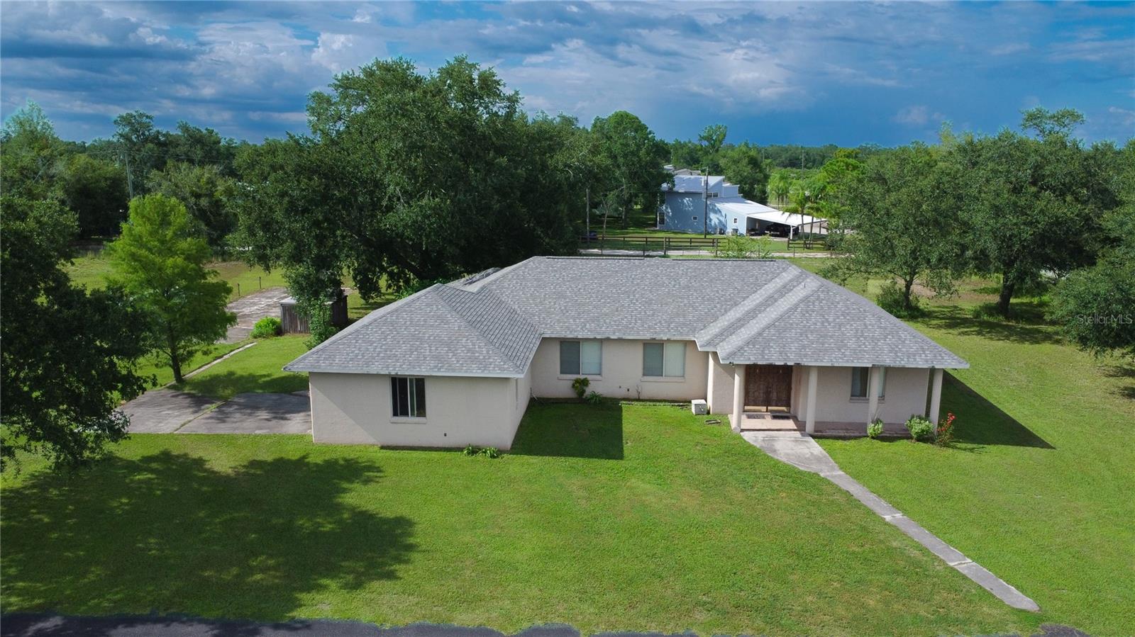 Spacious 3-Bedroom Home on Agricultural Acreage – Built for Comfort & Possibilities. Discover country living with modern convenience in this beautiful 3 bedroom, 2 bathroom concrete block home built in 2000. Boasting 2,221 sq ft under air (3,341 sq ft total), this residence offers a desirable split floor plan, open living spaces, and recent upgrades—including a new roof in 2023. The oversized kitchen is the heart of the home, featuring abundant counter space, a center island, and an open layout perfect for entertaining. French doors lead to a screen-enclosed lanai, creating a seamless indoor-outdoor flow. The primary suite is a private retreat with dual walk-in closets and a massive walk-in shower, plus a separate soaking tub for relaxation. The interior laundry room and 2-car attached garage add everyday convenience. Situated on land zoned A-5, the fenced property offers potential for livestock and horses, along with an RV parking pad equipped with well, septic, and electric access. Enjoy peace of mind with a concrete block build, a spacious layout, and plenty of room to grow.