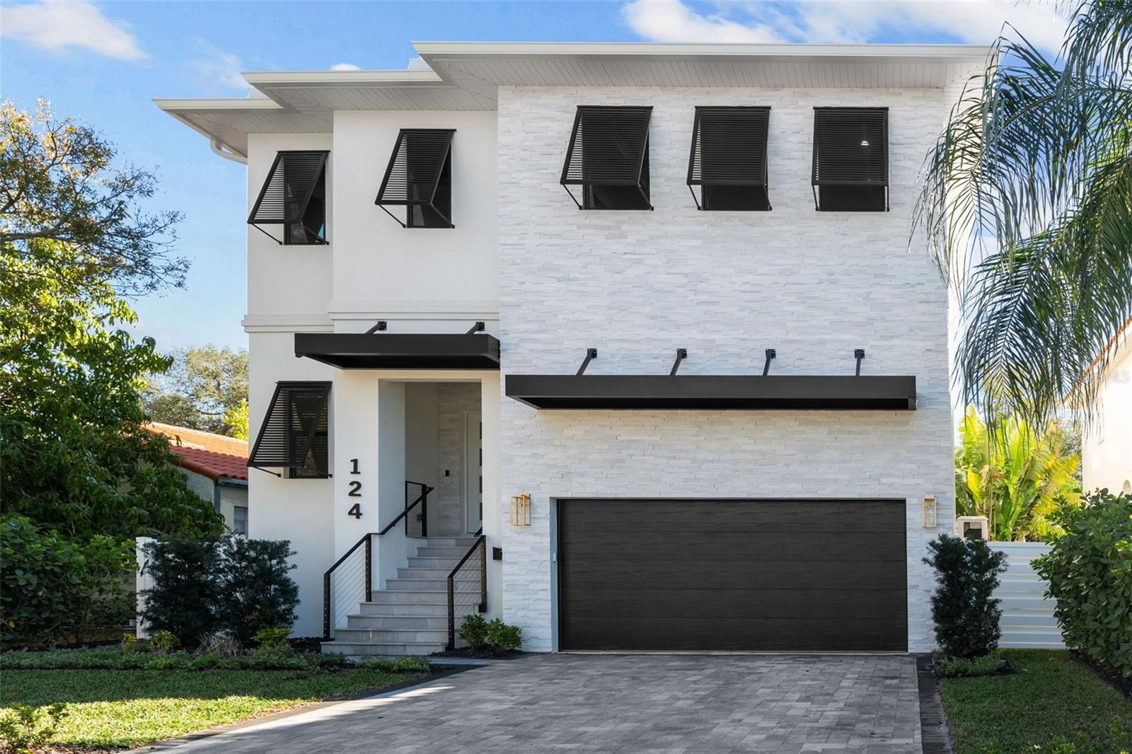 Welcome to DAVIS ISLANDS, one of Tampa's most prestigious neighborhoods. This exceptional, recently built 4-bed, 4 ½-bath home, with office and loft, radiates timeless elegance. Walkable to Davis Islands Village, it features a seamless great room-kitchen connection with Shaker-Euro cabinets, gas Thermador appliances, quartz counters, and a wine gallery. The entrance impresses with double doors, a lit home address, and a stone veneer accent. A brick paver driveway leads to the 2-car garage with EV chargers. Upgrades include PGT windows, 8 ft solid doors, and 5 3/4’’ baseboards. Enjoy audio throughout, a gas tankless water heater, epoxy garage floors, vinyl fence, and 4 WAP's for high-speed internet. Icynene insulation, soundproofing, and Advantech subflooring ensure tranquility. Wide plank wood, marble, and porcelain tiles adorn the floors. The 28 ft. covered lanai, Weber outdoor kitchen, and pool create a delightful outdoor space. The fenced yard, professionally landscaped with irrigation and rain sensor, adds appeal. The home, equipped with a generator, emphasizes convenience and preparedness. Comprehensive upgrades showcase meticulous attention to detail.