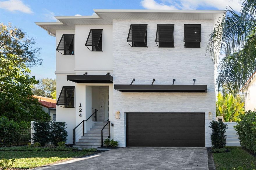 Welcome to DAVIS ISLANDS, one of Tampa's most prestigious neighborhoods. This exceptional, recently built 4-bed, 4 ½-bath home, with office and loft, radiates timeless elegance. Walkable to Davis Islands Village, it features a seamless great room-kitchen connection with Shaker-Euro cabinets, gas Thermador appliances, quartz counters, and a wine gallery. The entrance impresses with double doors, a lit home address, and a stone veneer accent. A brick paver driveway leads to the 2-car garage with EV chargers. Upgrades include PGT windows, 8 ft solid doors, and 5 3/4’’ baseboards. Enjoy audio throughout, a gas tankless water heater, epoxy garage floors, vinyl fence, and 4 WAP's for high-speed internet. Icynene insulation, soundproofing, and Advantech subflooring ensure tranquility. Wide plank wood, marble, and porcelain tiles adorn the floors. The 28 ft. covered lanai, Weber outdoor kitchen, and pool create a delightful outdoor space. The fenced yard, professionally landscaped with irrigation and rain sensor, adds appeal. The home, equipped with a generator, emphasizes convenience and preparedness. Comprehensive upgrades showcase meticulous attention to detail.