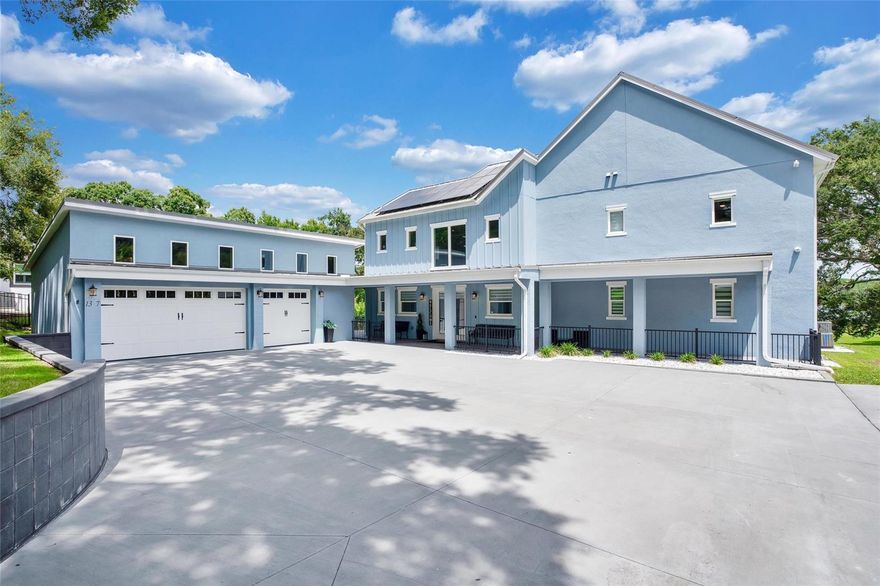 Discover the extraordinary charm of this nearly 2-acre lakefront haven situated in Ocoee-Winter Garden. Whether you're a hobbyist, a car collector, a business professional, or an investor, this property offers the perfect canvas. Encompassing a vast 6,425 square feet of total gross space, it all unfolds against the backdrop of the serene Spring Lake. This scenic lake not only offers picturesque views but also provides the opportunity for boating, skiing, and fishing.

This residence goes above and beyond by catering to various interests. Imagine having your very own podcast studio, a generously sized 3-car garage, energy-efficient solar panels, and a separate workshop building. The journey begins with an impressive entrance featuring soaring ceilings that set the tone for the meticulous craftsmanship found throughout. The heart of the home boasts an expansive open-concept chef's kitchen adorned with handcrafted cabinetry, quartz countertops, state-of-the-art appliances, and breathtaking views of the lake.

Prepare to be enthralled as you explore the luxurious Owner's Retreat. This haven of comfort grants access to a private terrace that gazes out onto the lake, creating a truly enchanting escape. The Owner's Spa bath amplifies the sense of opulence, while an expansive wardrobe dressing area with additional washer and dryer ensures storage is never a concern.

The outdoor space harmoniously blends relaxation and recreation, featuring a capacious screened patio deck, a glistening pool, a covered outdoor living room, and captivating views of the tropical lake surroundings. Don't let this unparalleled opportunity slip away – secure your chance to experience this remarkable estate firsthand by scheduling a private tour today. Your dream of lakeside luxury living awaits.