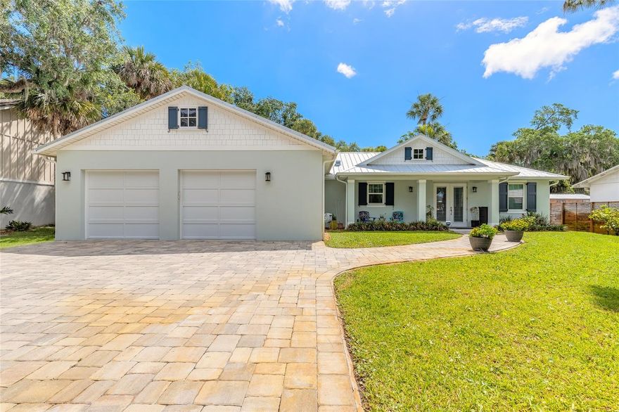 Coastal-inspired living meets quality concrete block construction in this beautifully expanded 2BR/2BA home built in 2018 and thoughtfully enhanced in 2024. From the moment you step inside, the home delivers an immediate “WOW” factor with its spacious open-concept design seamlessly blending the living room, kitchen, dining area, and family room into one bright and inviting gathering space, highlighted by gorgeous vaulted shiplap ceilings throughout the main living areas. Designed with a desirable split-bedroom floor plan, the oversized primary suite features custom built-ins, 2 large walk-in closet, and a private bath retreat. Abundant natural light pours through newly installed hurricane-rated doors and windows accented with 2-inch wood blinds, showcasing the soaring ceilings and soft coastal-inspired color palette throughout the home.
The open kitchen overlooking the Living area is beautifully appointed with granite countertops, stainless steel Samsung appliances, upgraded soft-close cabinetry, and a convenient drawer-style microwave. Additional interior upgrades include dual electrical panels, a spacious mudroom/laundry area with room for an extra refrigerator, and a gas-powered tankless hot water heater. Also includes Marwal electronic cleaning device for whole house assistance.
Outside, major upgrades continue with a durable metal roof installed in 2018, full-house gutters, and an expansive rear deck spanning the entire length of the home, creating the perfect space for entertaining or relaxing outdoors. The fully fenced backyard offers gates on both the north and south sides for added privacy and convenience, with ample room to add a future pool. A well-fed inground sprinkler system keeps the beautifully maintained yard lush year-round. There is a receptable built in for a Generac. 
The oversized 2-car garage includes additional storage space along with a REAR garage door opening to a pavered area behind the home for complete drive thru accessability. A massive 35’ x 12’ freestanding storage building with electric and two separate rooms provides exceptional flexibility for hobbies, workshop space, equipment, or additional storage. The property also features two EV/RV plugs and a house-wide alarm system that can be conveniently programmed from your smartphone.
This move-in-ready property combines modern construction, thoughtful upgrades, exceptional indoor-outdoor living, and a highly functional layout designed for both entertaining and everyday comfort. Conveniently located close to local shopping, the NSB Library, Canal Street activities, and the beautiful beaches of New Smyrna Beach, this well-built fortress is truly a must-see.