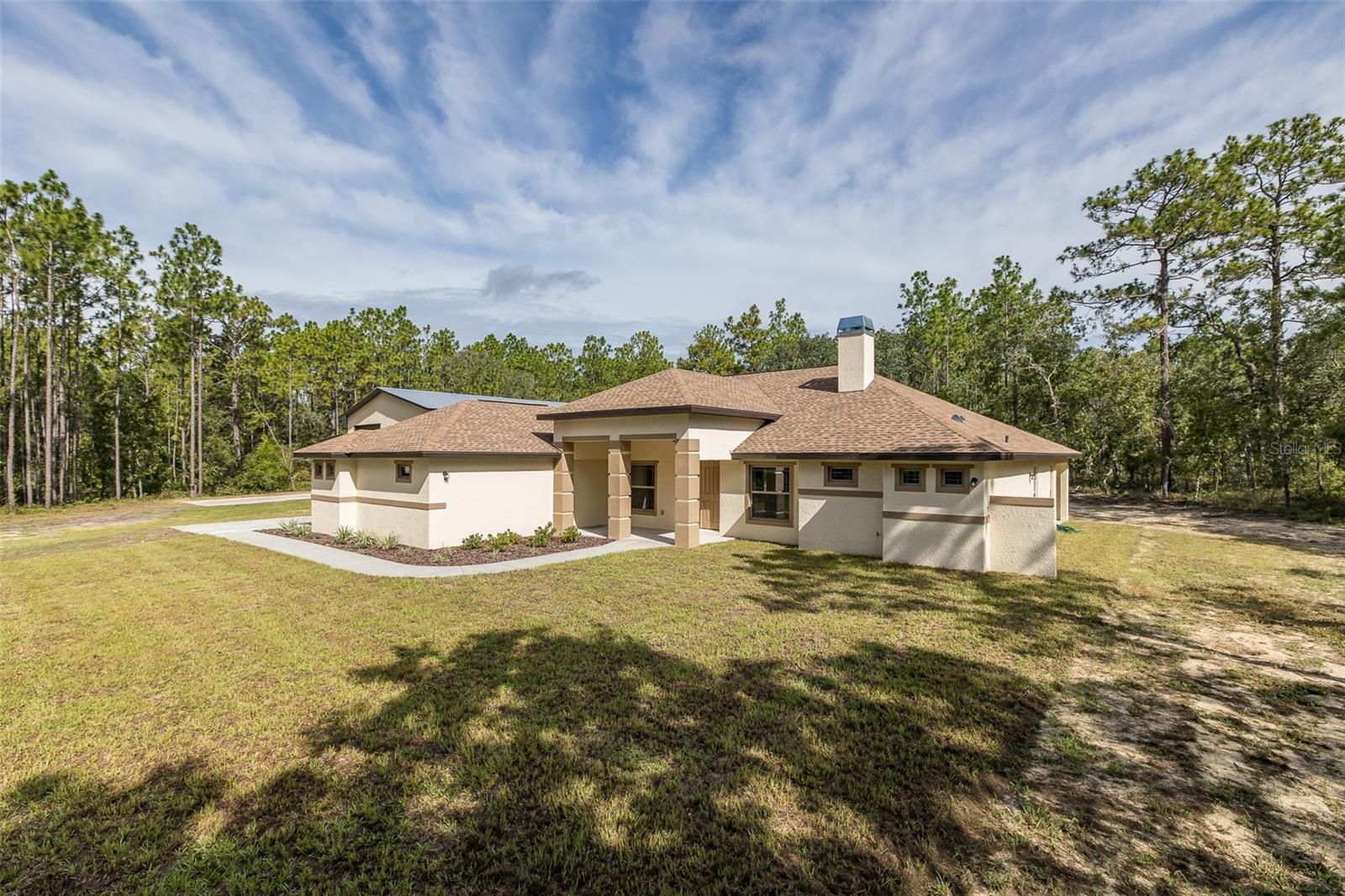 BRAND NEW HOME...This 2025 country-style home on 9.6 private wooded acres in sought-after Country Haven Estates! Nestled in the peaceful enclave of Country Haven Estates, this 9.6-acre wooded estate offers privacy, serenity, and the perfect setting for your dream home. Envision a charming country-style cottage with vaulted ceilings, wood-plank tile floors, and an open-concept living space centered around a cozy fireplace and a wall of sliding glass doors opening to a covered porch with tranquil forest views.
The kitchen features granite counters, a breakfast bar, nook, and pantry. A split layout provides a luxurious primary suite with tray ceiling, uplighting, dual walk-in closets, and spa-like bath. Two guest bedrooms, a versatile den, and even a HIDDEN BUNKER ADDS A UNIQUE APPEAL. A spacious laundry room with sink, IMPRESSIVE OVERSIZED THREE DOOR GARAGE GEARED AS THE ULTIMATE MANCAVE FOR ALL YOUR HOBBIES WHICH IS IS EQUIPED WITH ELECTRICITY AND PLUMBED FOR WATER. The fully fenced grounds make it both practical and inviting.
Located just minutes from Weeki Wachee Springs, the Suncoast Trail, and Pine Island Beach, with easy access to the Suncoast Parkway for a quick commute to Tampa Bay, this property offers the perfect blend of rural charm and convenience. Deed restrictions ensure quality, and a survey is included.