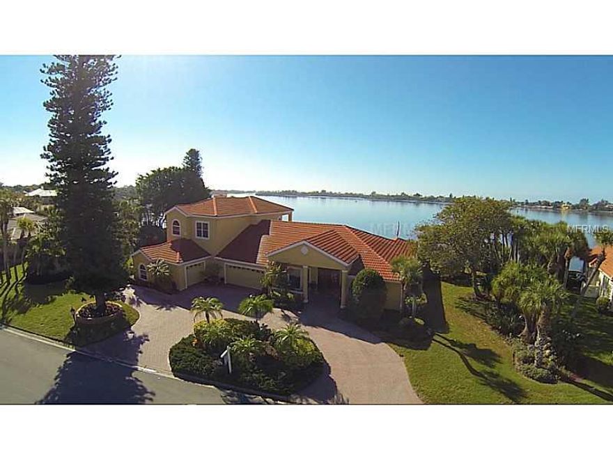 Spectacular Custom Built Home on a 30,000 sf lot with 252' of Direct Bayfront  including 2 Docks & 2 Lifts. The moment you enter through the Hand Carved Wood & Glass Doors the views of the ICW and Blackburn Bay mesmerize you. Large fenced side yards, a rarity, perfect for pets, outdoor parties and entertaining. In 1998 the house was demolished and a new home was constructed. Interior features a Gourmet "Chefs" Kitchen with top of the line SS appliances, wood and glass cabinets, and granite countertops with tumble stone backsplash and enormous center island with sink and cooktop. Fully mirrored Gym perfect for the work out enthusiast. FR with large Coral wood burning fireplace with extended area for pool table & wet bar.  Living Room has a Eurotech Wall unit that remains with the home.  Decorative ceilings in LR & DR. Professional faux painting; FloLogic  water shut off system; State-of-the-Art Video and Security System; Whole House Water Filtration System; Additional Storage Area for Hurricane Shutters & More; Mud Room with Refrigerator & Ice Maker; Brick circular driveway and decks; 5 acres of submerged land including the well known "Bird Island" Rookery; mature landscaping and extreme privacy. Phenomenal Sunsets and wild life come at no additional cost
