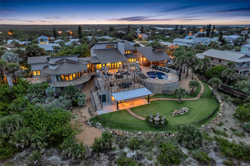 Magnificent and luxurious describes this one-of-a-kind direct ocean front home with guest house. This 6-bedroom 5/2 bath home is located on 1.15 acres, and is one of the largest oceanfront parcels on prominent north beach in New Smyrna Beach. This home has gone through a multi-million-dollar renovation. Surrounded by hand laid stone walls, and flagstone paths and terraces that connect the main home to the guest house and several surrounding garden terraces. The main home has a first-floor master bedroom with expansive panoramic views of the ocean and a spectacular 24 x 10 walk thru closet and located on the south wing of the home for privacy. Beautiful large new eat-in kitchen with custom cabinets, high end granite, spacious island with gas cook top, custom appliances, drink drawers and gorgeous views of the ocean and pool. Large formal dining and living room with expansive ceilings and oak beams open up to a massive flagstone outdoor entertaining deck with 1 of 2 outdoor kitchens. Cozy large family room off kitchen with coffered ceilings brings a wonderful coastal feel throughout. 2nd floor consists of 3 bedrooms, 1 bedroom being the 2nd master bedroom and 2 full baths. Treat your guest to their own private ocean view space with this one-bedroom guest cottage that has all the luxury of the main home. Large open floor plan with massive oak beams throughout. Granite kitchen, eat-in nook, kitchen island, private deck and Ocean views from living room and kitchen. 3 car garage with temperature control wine cellar. The workmanship and materials in this house make this hard to duplicate. The home features are essential to understanding the design and beauty of the property. Don’t miss out on this opportunity to own one of finest Ocean front homes in New Smyrna Beach. ALL MEASUREMENTS AND INFORMATION ARE DEEMED TO BE ACCURATE BUYERS AND BUYERS AGENT TO VERIFY **