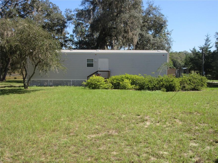 Beautiful one acre to roam located on a pond with a view of wildlife. Property mostly fenced, 10x15 storage shed, 40x30 paved area for parking or future carport, etc. Property includes a 2018 park model mobile home 8x48 with one bedroom, one bath, totally livable mint condition. Home was designed to live while you are building on additional portion of property. This is why it doesn't show home in property appraiser. Only 2 miles from Winn Dixie shopping center in the heart of the Ocala National forest, Lakes, rivers, hunting and many out door activities. Only an hour and a half to Daytona (Atlantic Ocean), one and half hours to Gulf of America. Hurrry! Build your dream home and have a place to stay while you are building!