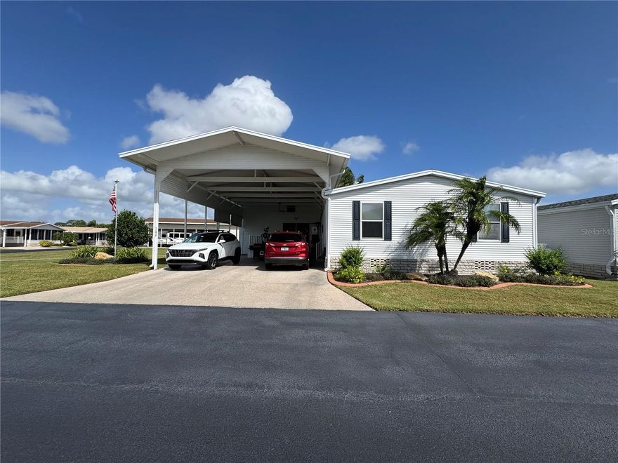 Welcome to Lily Lake – Your RV Port Dream Home Awaits!

Located on a desirable corner, pie-shaped lot, this premier 3-bedroom, 2-bath Palm Harbor home offers comfort, functionality, and plenty of space for all your Florida lifestyle needs.

Enjoy covered RV parking, a one-car golf cart garage with roll-up door, and ample parking for vehicles and toys. Above the golf cart garage, a spacious loft provides the perfect bonus area for a craft room, workshop, or extra storage.

Step inside to find a bright and open floor plan featuring vaulted ceilings, laminate flooring, and designer trim accents in the living area. The kitchen is both functional and inviting, with a walk-in pantry, breakfast nook, and separate dining area — ideal for everyday meals or entertaining guests.

The split-bedroom layout offers privacy and space for everyone. The primary suite includes a large ensuite bathroom with double vanities, a jetted garden tub, and a walk-in shower with built-in bench seating. The second bedroom features charming interior glass French doors, making it perfect for a home office, den, or library. The third bedroom is equally inviting, with fresh carpeting, a ceiling fan, and easy access to the second full bath.

Outdoors, enjoy a covered patio lanai under the carport — perfect for relaxing or entertaining — while still having plenty of room for your RV, vehicles, and golf cart. Perfect for entertaining after a round of golf.

Lily Lake residents enjoy exceptional amenities, including a nine-hole golf course, clubhouse, pickleball, tennis, bocce ball, and racquetball courts, a pool with separate Jacuzzi Hot Tub area and a small fitness center. Golf Carts are welcome through the community, making it easy to enjoy  all Lily Lake as to offer!

This home truly has it all — space, style, and storage — in the friendly, gated Lily Lake community, where you can live the resort lifestyle every day!