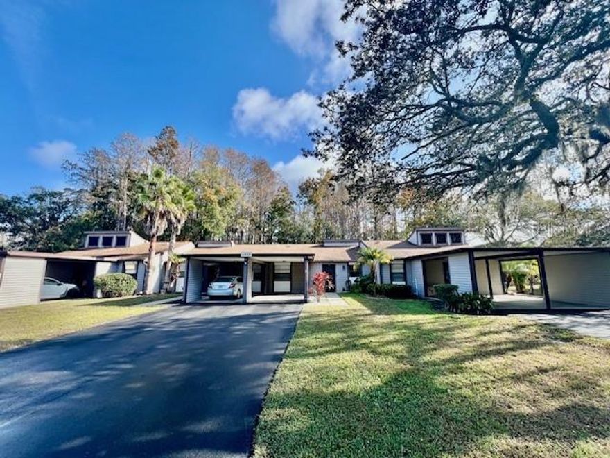 WELCOME TO YOUR FANTASTIC HOME at 11536 Baywood Meadows Dr #3, New Port Richey in the serene community of Baywood Meadows. The UPDATED VILLA-STYLE condo features 2 bedrooms, 2 bathrooms & 1 assigned carport & PRIVATE driveway fitting 2 more vehicles plus  plenty of open parking for your guests. This POPULAR, ONE-STORY VILLA is a very DESIRABLE CORNER UNIT! The front of your unit has SERENE POND/WATER VIEWS while the back yard has CONSERVATION VIEWS. As you step into the dedicated foyer with a built-in coat & pantry closets, you'll LOVE the ceramic tile laid diagonally or laminate floors throughout the home (no carpet anywhere). The interior has just been FRESHLY PAINTED (12/2025) brightening the space. The FABULOUS kitchen features nice appliances, expansive laminate counters, breakfast bar with pass through opening into the dining area & plentiful cabinets with handles. The dining room features built-in shelving while the living room has a ceiling fan & double French doors to the screened & covered lanai. NATURAL SUNSHINE streams through the multiple windows ILLUMINATING the interior together with the light fixtures. The windows are dressed with custom fitted blinds and/or rods with curtains. The OPEN FLOOR PLAN consists of the foyer, kitchen, living & dining rooms. The primary bedroom can easily accommodate king-size furniture & has a ceiling fan, walk-in closet (approximate dimensions 6'x5') & en-suite. The private bathroom has a step-in shower, storage cabinet vanity with stone counter, lights & toilet. In this split bedroom plan, the other bedroom features a spacious closet & light. The 2nd bathroom has a tub/shower combination & modern vanity with stone counter. Enjoy cool evening breezes in the screened/covered lanai which can be accessed from the living room or the primary bedroom. There is a storage closet in the lanai perfect for your beach & sporting gear. MASSIVE BONUS: washer & dryer are included for tenant's convenience. Rent includes lawn care, cable TV, internet & community amenities like swimming pool, tennis courts, beautifully landscaped grounds & pond with fountain, clubhouse with meeting space & gym. Your pet is welcome. Location is IDEAL near schools, shopping, restaurants, medical plazas, places of worship, beaches & tourist attractions. MAKE THIS YOUR FUTURE HOME!