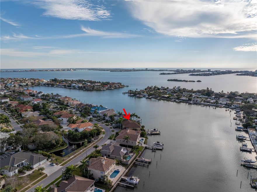 Experience the ultimate Florida lifestyle in this luxurious 4-bedroom, 4.5-bathroom contemporary "smart" home, perfectly situated behind the exclusive gates of Pasadena Yacht and Country Club. This thoughtfully updated home boasts all updated systems to include HVACs, roof, etc. (you can just move right in!), soaring ceilings, a high elevation, gleaming  Iroko "Antico" hardwood flooring, and glistening water views that welcome you as soon as you step inside. The open living and dining rooms are perfect for entertaining guests, while the renovated chef's kitchen is a culinary masterpiece, complete with high-end appliances, custom wooden cabinetry, 2 islands, 3 Fisher and Paykel dishwashers, and a Wolf oven, among other features. The first floor bedroom, with a full bathroom, water views, and access to the outdoors, is perfect for guests or use as a home office. The hydraulic elevator is perfect for those who prefer not to use the stairs. The expansive primary bedroom on the second floor opens to a large balcony with breathtaking sunset views, and the primary bathroom is equally grand, with a large shower, jetted garden tub, and designer closet system. Two additional bedrooms, each with an ensuite bathroom, complete the second floor. The full in-home theatre is ideal for a movie night in, while the Pentair heated saltwater pool and spa, and the outdoor kitchen with high-end appliances, including a Heston grill and hibachi station, are perfect for soaking up the sun and grilling delicious meals. The newly redesigned dock offers 2 boat lifts, water, electric, and automatic dock lights, making it perfect for the boat enthusiast. Other features of this stunning home include a reverse osmosis water filtration system, whole house generator, full home security system, and an oversized 2-car garage. As a bonus, owners within the community can enjoy a coveted PYCC membership, with access to tennis, golf with a new driving range, and a renovated clubhouse and marina, without a waitlist. Don't miss out on this incredible opportunity to live the ultimate Florida lifestyle in a private, luxurious, and "smart" home that has it all. Bedroom Closet Type: Walk-in Closet (Primary Bedroom).