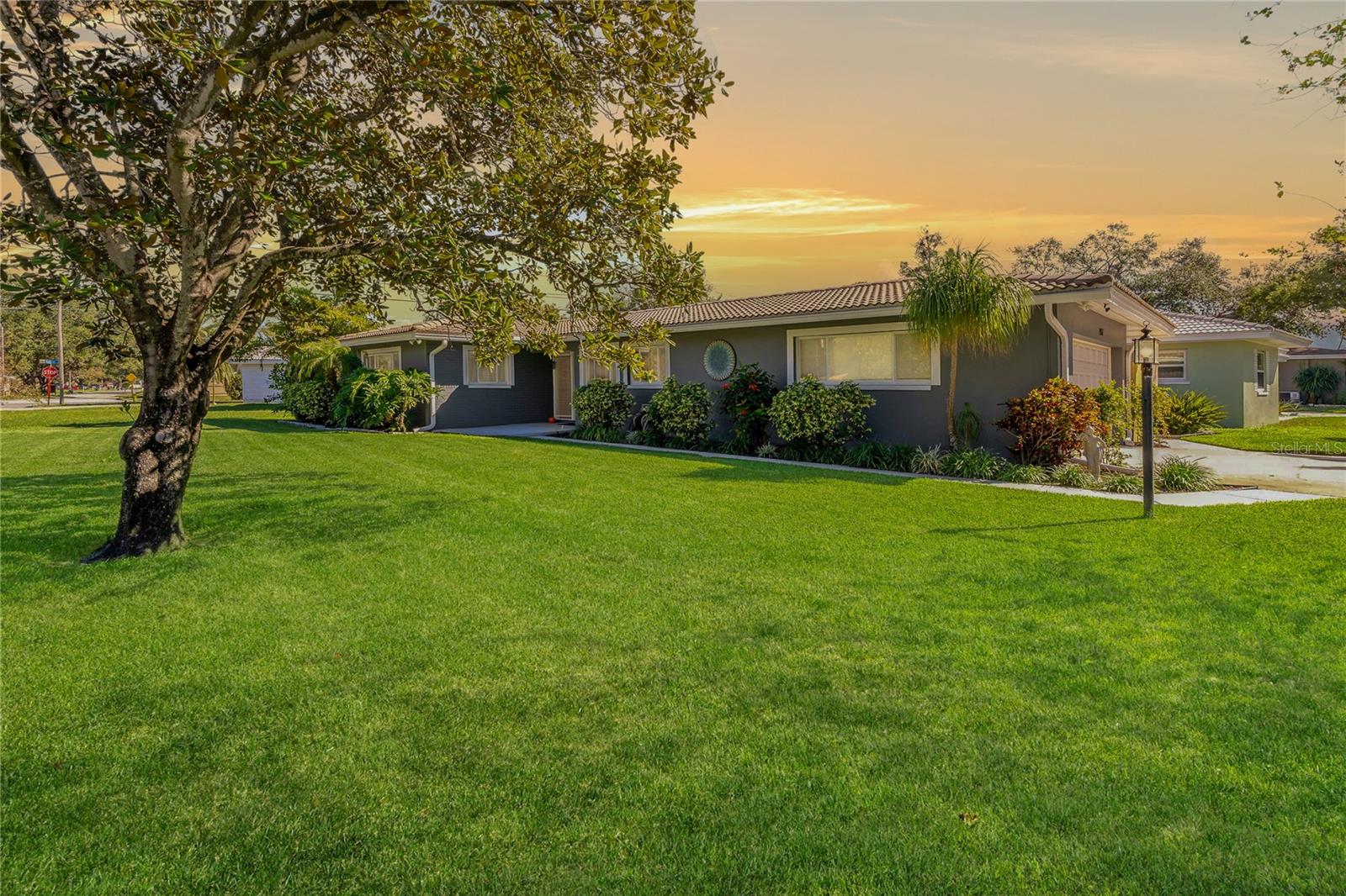Welcome to this immaculately maintained home with eye-popping perfection curb appeal on a large corner lot! This home is high and dry, located in the highly sought-after Sherwood Heights community of Clearwater! Pride of ownership shines through every inch of this meticulous 2-bedroom, 2-bathroom single-family home. There is a 3rd room that could be used as a bedroom, office or bonus room. With smart design and updates, this home is as charming as it is functional ~ perfect for enjoying everything sunny Clearwater has to offer. As you step inside, you’ll be greeted by an open and airy floor plan that seamlessly blends the kitchen, family room and dining room. Natural light pours in through the updated windows, creating a cheerful and inviting space. The kitchen is a true masterpiece, featuring wood plank porcelain tile floors, GE stainless steel appliances (only three years old), and thoughtful touches like deep drawers, a lazy Susan, pull out drawers, tile backsplash accents, breakfast bar and window right above the sink to admire the view outfront. The primary suite offers a relaxing retreat, with a beautifully updated bathroom that showcases a floor-to-ceiling tiled shower and a sleek white quartz countertop vanity. The guest bathroom is equally impressive, with a tiled shower and tub combo and a modern vanity. The fully fenced backyard is a private oasis complete with a storage shed and plenty of room for outdoor fun or relaxation. The tile roof has been professionally cleaned every two years, ensuring durability and longevity. Fresh exterior paint from 2020 adds to the beautiful curb appeal, while updated ceiling fans and light fixtures bring a modern touch to every room. The oversized 2-car garage offers 2 attic access points with plywood flooring, making storage a breeze. This property offers unbeatable flexibility with no HOA fees or deed restrictions. You’re just minutes from Clearwater’s best attractions ~ beaches, parks, golf courses and vibrant downtown areas like Safety Harbor and Dunedin. Plus, with proximity to St. Pete and Tampa airports, getting where you need to go is a snap. Schedule your showing today and fall in love with this Clearwater treasure!