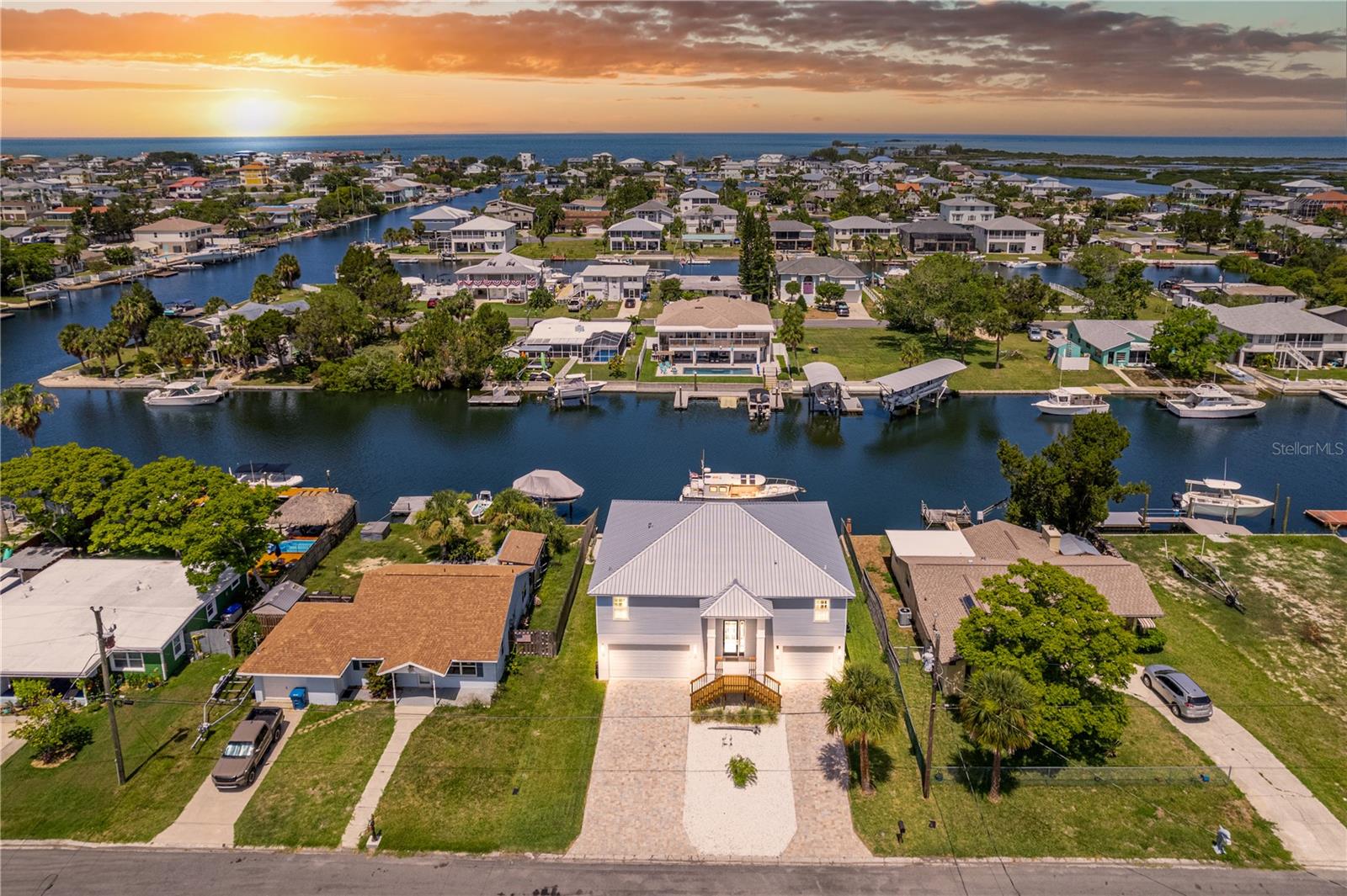 LOOKING FOR A NEW WATERFRONT HOME? This 2023 Nautically Nice Coastal Custom Home in Hernando Beach is Just Boat Minutes to the Open Gulf and is Situated on a Deep Wide Canal. You will Love that the Back offers Ever-Changing Western Sunset Views. Spacious Backyard. There is a Fun Small Beach Area to dip your toes in while soaking up the Sun. You have Room to Add your Own Touches too.. Maybe a Future Pool? Gazebo? Summer Kitchen? The 67 Ft Seawall & the Floating Boat Dock are New & is Ready for Your Water Toys. Talking about the Future.. This home is pre-wired for an elevator and has an ELEVATOR SHAFT. Let's Start at the Front: Seashells, Palm Trees & Pavered Driveway. This is a TWO (2) BEDROOM with an Office. Step Through the Front Door to a Pretty Foyer & Up the steps to An Open Vaulted Ceiling Floor Plan. Everything has Coastal Touches. The Kitchen is Stunning with White Shaker Wood Cabinets with Crown Molding, Leathered Finish Granite Countertops, High End Stainless Steel Appliances, White Farmers Sink with Spray Faucet, Breakfast Bar Island with Pendent Lights. Right off the Great Room is the Upper Porch with Cable Railings that is Perfect for your Morning Coffee or Enjoying the Coastal Breezes & Gorgeous Sunsets with your Evening Beverage of Choice. The Primary Bedroom is Private & has a Large Walk in Closet with Organizer, Dual Vanities & a Huge Walk in Shower plus has it's own set of sliding glass doors going out to the Back Porch. The Second Bedroom is spacious and has a Coastal looking Guest Bathroom with a Large Walk in Shower. Laundry Room has a closet with washer & dryer. Let's talk about the Garage aka the Mancave... It is Huge... As big as the home itself! Plenty of Room for your Vehicles, Toys & Workshop. This home is not just pretty but also Well Built to the Newer Building Codes. Impact Windows, Doors, Sliding Glass Doors & Garage Doors. Metal Roof with a Secondary Water Barrier Underneath. The Age & Quality of your Home will offer you Peace of Mind. It will also provide lower insurance costs. Short Term Rentals are Allowed in this Neighborhood. WHY BUILD? This Home is Move In Ready & Barely Used. Come.. Feel Like Your On Vacation Every Single Day!