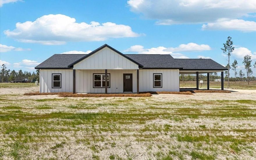 One or more photo(s) has been virtually staged. Brand New, Beautifully Built, Ready for You, 2026 new construction home located in Suwannee County, offering the perfect blend of modern comfort and peaceful country living. This single-story home features 1,496 heated square feet (2,288 total) with 3 bedrooms, 2 bathrooms, and a spacious open floor plan designed for both everyday living and entertaining. Enjoy a bright and inviting kitchen complete with stainless steel appliances, flowing seamlessly into the main living area and wood slat accents add warmth and a modern designer touch. The primary suite offers a beautiful tiled walk-in shower and an extra-large walk-in closet, creating comfort and space. With accent walls that brings texture, warmth, and a high-end custom feel. Situated on 5 gorgeous acres with paved road frontage and lime rock driveway, this property also includes a 2-car carport and enjoying your own private lined pond, adding to its charm and privacy. Inside, you’ll find thoughtful details like custom built-in cubbies in the laundry room and unique, special touches throughout that truly make this home stand out. This is a must-see property that offers space, style, and that perfect North Florida feel all in one!