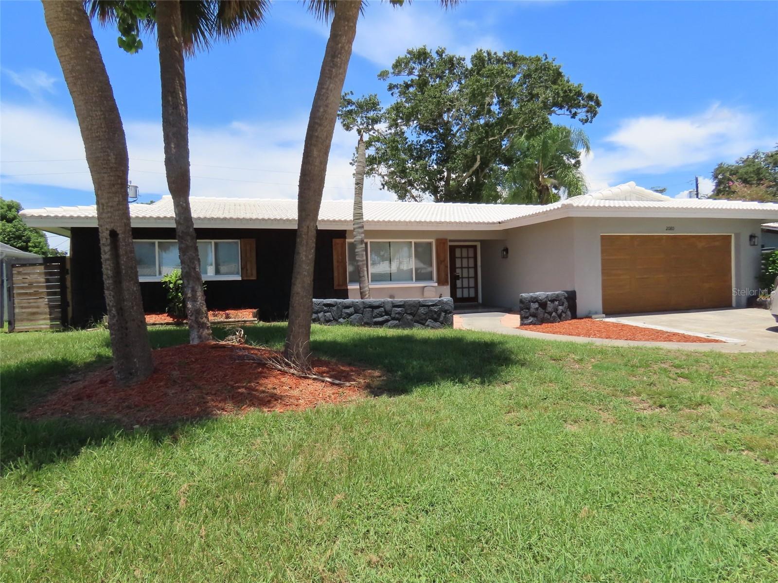 Welcome to 2080 Attache Ct. - a spacious 4-bedroom, 2-bath home with a 2-car garage, ideally located in central Clearwater. Nestled on a generous lot in Imperial Park, this property features a welcoming foyer entry that opens to a large living room with a charming wood-accent wall, creating a warm and inviting atmosphere. The kitchen is well-equipped with stone countertops, breakfast bar seating, and opens to the dining area—perfect for both everyday living and entertaining.
The bedroom layout includes the primary bedroom and two guest bedrooms situated on one side of the home, while a fourth bedroom is located on the opposite side, offering flexibility for use as a private guest room, home office, or hobby space. Both bathrooms have been modernized in recent years, offering a clean and updated feel. Step outside to enjoy the expansive fenced backyard, full of potential for outdoor living and. The covered porch is ideal for relaxing or entertaining, and a large shed provides convenient storage for lawn equipment or outdoor gear. The home also features a durable tile roof.
This centrally located home is just 15 minutes to Clearwater Beach, 30 minutes to downtown Tampa, 25 minutes to Tampa International Airport, and 30 minutes to downtown St. Petersburg. Nearby parks include Crest Lake Park (7 minutes away) and Moccasin Lake Nature Park (11 minutes), offering excellent recreational opportunities.
All information is believed to be accurate but is not guaranteed. Buyers and agents to verify all information pertinent to their purchase decision.