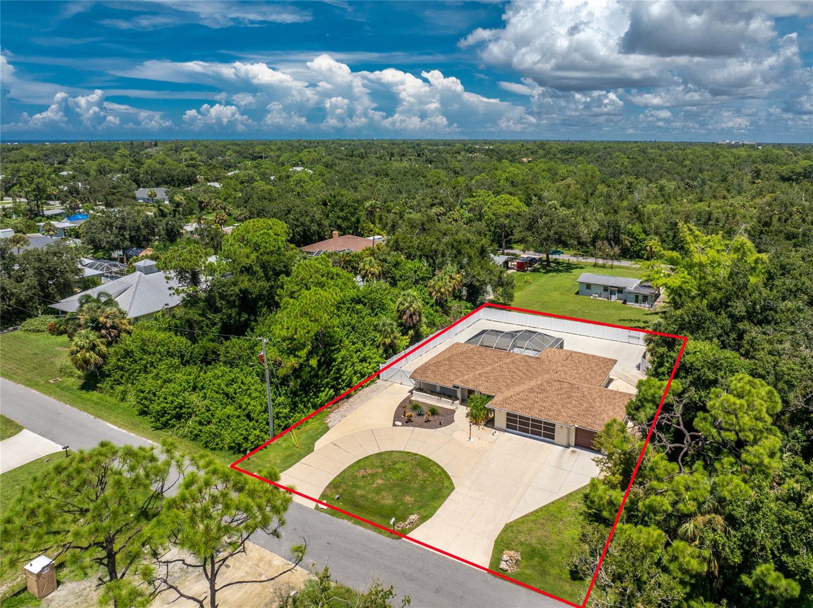 A coastal retreat less than a mile from Manasota Key Beach and the public boat ramp, this two-bedroom, two-bathroom, three-car garage pool home offers an ideal combination of comfort, privacy, and proximity to the water. Tucked away on a quiet dead-end street and surrounded by wooded land on both sides with a privacy-fenced backyard, it provides a peaceful setting while still keeping you close to the coast. The property is designed for those who appreciate the Florida lifestyle, featuring a spacious circular driveway that extends through double gates to a reinforced rear concrete pad (6”, 4000 PSI with fiber, rebar, and wire mesh). This area provides ample space for boat, RV, or jet ski parking, eliminating the need for off-site storage and offering flexibility for recreation or even a private pickleball court. Inside, the split floorplan creates a functional flow between living spaces. The formal living and dining rooms overlook the pool through sliding glass doors, while the kitchen features white cabinetry, a tray ceiling, and a breakfast bar. The kitchen opens to the family room with vaulted ceilings and direct pool access, creating an easy connection between indoor and outdoor living. The primary suite includes a walk-in closet, sliding glass doors leading to the pool, and barn doors providing privacy from the rest of the home. Its ensuite bath features an oversized dual-sink vanity and a beautifully tiled walk-in shower with a frameless glass door. The guest bedroom includes a walk-in closet and is located next to the guest bath, which also serves as a pool bath with a tub and shower combination. Outdoors, the screened lanai (new in 2024) and heated pool (resurfaced in 2023) offer a private and relaxing retreat. The home includes Pella impact windows and doors, plantation shutters, and a screened and insulated garage door. Major updates include a 2021 roof, HVAC system with warranty, water heater, and 2024 attic insulation and landscaping. All furniture conveys, providing an effortless move-in experience. Located near Lemon Bay and the Gulf, this home makes it easy to spend mornings on the water and afternoons relaxing at the beach. The Island of Venice, Wellen Park’s CoolToday Park, and Historic Dearborn Street are all nearby, offering dining, shopping, and local entertainment. Nature lovers can also enjoy Manasota Preserve, home to gopher tortoises, otters, and nesting sea turtles during the summer season. For anyone seeking a comfortable and convenient coastal home near the beach and boating access, this Manasota Key area property at 1600 Thomas Street delivers the true Florida lifestyle.