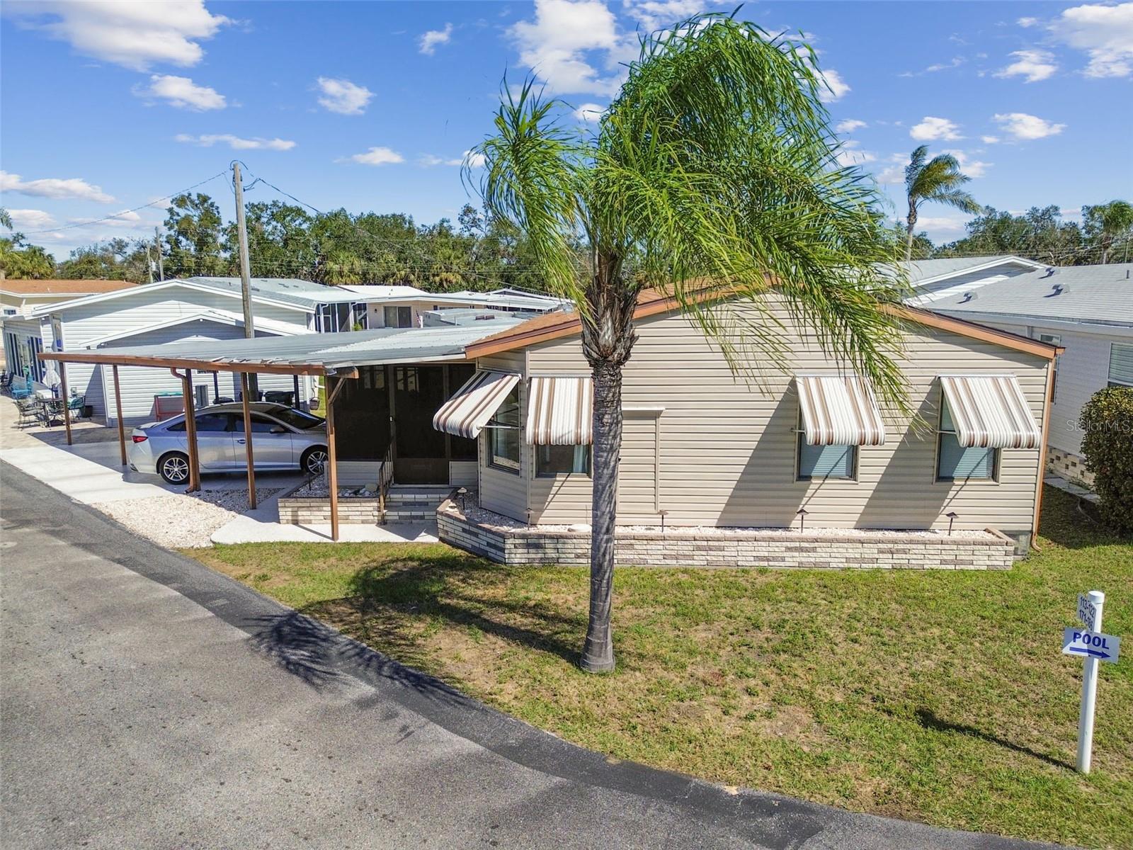 Discover comfortable living in this delightful mobile home nestled within Southwinds 55+ mobile home community, just minutes from Siesta Key! This two-bedroom, two-bathroom home features a thoughtfully designed layout that fills the living spaces with natural light. The kitchen, complete with appliances, seamlessly connects to the living area and features a bar area perfect for entertaining. The practical layout extends to the exterior, where a large screened in patio awaits for enjoying fresh air and outdoor moments. The home also includes convenient outdoor storage with a washer and dryer. This home offers comfort and convenience in a well sought after and welcoming neighborhood. The Southwinds community includes a community pool, shuffleboard, pickleball, bocce ball, and horseshoe courts, a putting green, picnic area, pool room, library, and a recreation hall. Book your tour today to experience all that this wonderful community has to offer!