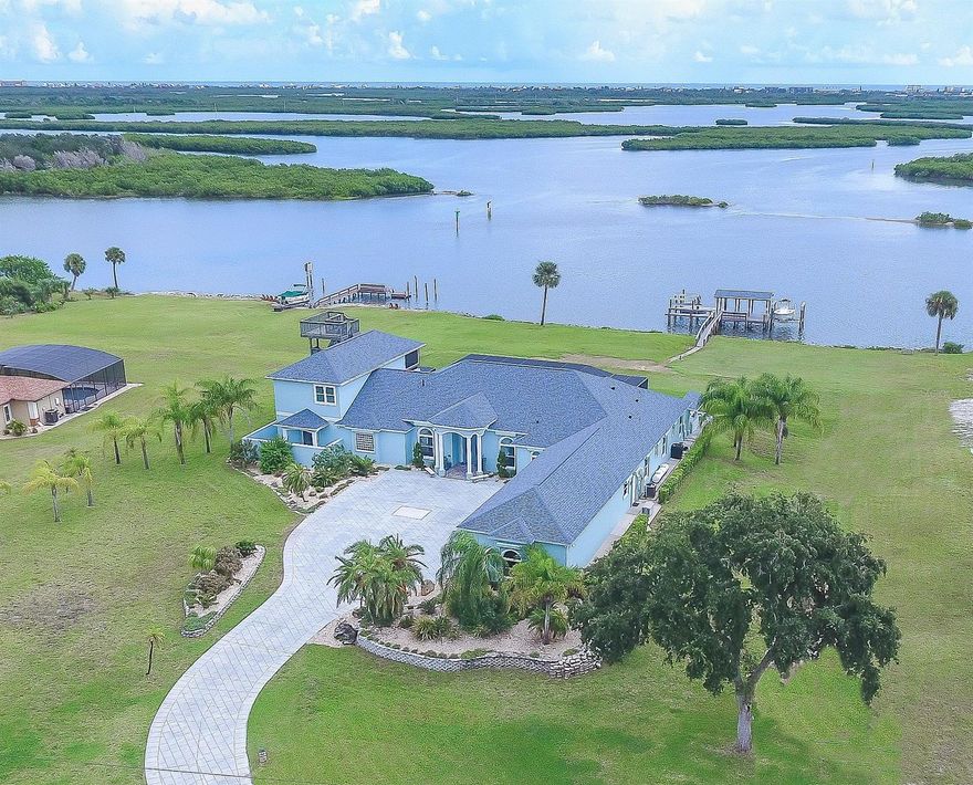 FABULOUS ONE OF A KIND DIRECT INTRACOASTAL ESTATE HOME. ONLY A 12 MINUTE DRIVE TO CANAL ST IN NEW SMYRNA AND 18 MINUTES TO FLAGLER AVE AND BEACH. LOCATED ON 5+ ACRES w/OVER 250 FT DIRECT INTRACOASTAL FRONTAGE AND UNOBSTRUCTED PANORAMIC VIEWS OF THE RIVER. THE COVERED BOAT DECK HAS TWO BOAT LIFTS w/A FLOATING DOCK ON   DEEP WATER FOR ALL YOUR WATER TOYS. THIS 2006 CUSTOM BUILT RESIDENCE HAS 6 LARGE BEDROOMS (one bedroom is being used as an office), 6 FULL BATHS, CLUB/GAME ROOM, GOURMET KITCHEN, 4 CAR OVERSIZED GARAGE, INGROUND SCREENED SALTWATER POOL & SUMMER KITCHEN.  THE GOURMET KITCHEN INCLUDES A BUTLERS PANTRY, SEPARATE WALK IN PANTRY, TOP OF THE LINE 6 BURNER GAS WOLF RANGE, SUBZERO REFRIGERATOR, BOSCH DISHWASHER, CUSTOM MADE CABINETS & CENTER ISLAND. THE OPEN FLOOR PLAN WAS DESIGNED TO FEATURE WINDOWS WITH SPECTACULAR RIVER VIEWS FROM EVERY ROOM. THE OUTDOOR ENTERTAINMENT AREA  INCLUDES AN OVERSIZED SCREENED, SALT WATER POOL & SPA AND AN OPEN SEATING AREA WITH A 7 FT CUSTOM GRILL AND GAS FIRE PIT. THE MAIN BEDROOM IS A RETREAT OF ITS OWN w/SITTING ROOM, PRIVATE SCREENED PORCH, SEPARATE DRESSING AREA, 20X20 CUSTOM CLOSET, HIDDEN SAFE ROOM, COFFEE/REFRESHMENT CENTER, AND EN SUITE WITH SOAKING TUB, LARGE WALK-IN SHOWER, BIDET AND LOTS OF VANITY AREA.  THE SPECTACULAR FIRST FLOOR LIVING AREA IS COMPLETE AND COMFORTABLE JUST AS IT IS... HOWEVER THERE'S A BONUS AREA UPSTAIRS WITH A CLUB/GAME ROOM, CUSTOM BAR, SCREENED PORCH AND A PRIVATE BEDROOM AND FULL BATH. THE 3RD FLOOR OBSERVATION TOWER OFFERS TRULY AMAZING VIEWS OF THE RIVER & OCEAN AND THE BEST PLACE TO SEE ROCKET LAUNCHES.  STATE OF THE ART SECURITY SYSTEM COMBINED w/THE POWERED GATED ENTRANCE PROVIDES YOU CONTROL OF YOUR PRIVACY.  MANY EXTRAS INCLUDE BRAND NEW UPGRADED PGT HIGH WIND IMPACT TINTED WINDOWS AND GLASS DOORS, PLANTATION SHUTTERS, WHOLE HOUSE GENERATOR, POWER HURRICANE SHUTTER SYSTEM, NEWLY PAINTED INSIDE AND OUT, RV PARKING AND LOTS MORE. SHOPPING NEARBY AT PUBLIX & WALGREENS. ;Water: City