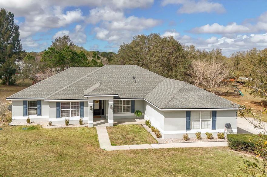 Situated on an oversized 0.85-acre lot in Black Bear Reserve, this renovated & well-kept four-bedroom home—with an extra bonus room—is sure to impress! Designer touches can be found throughout, starting with soaring ceilings and a brand-new open-concept kitchen that flows into the living area, perfect for entertaining. The kitchen features an oversized island, shaker cabinets with crown molding, quartz countertops, and a new LG stainless steel refrigerator, creating a modern and welcoming atmosphere. The roomy living space boasts new vinyl plank flooring and opens onto a generous 10'x28' screened porch overlooking the vast backyard—ideal for gardening, play, or pets. The split bedroom layout includes three secondary bedrooms with newer carpeting, each large enough for queen beds. Secondary bath has been upgraded with a subway-tiled shower, new vanity, and toilet. Primary bath completely remodeled in 2026 with a spa-like design, marble shower surround, glass doors, double vanity, and two walk-in closets.  Additional improvements include a new roof and drain field (2022), an updated interior electrical panel (2024), a smart hot water heater, new solid wood interior doors, baseboards and LG front-load washer and dryer set on pedestals (2025). You deserve a home you'll love—call to see your new address today!