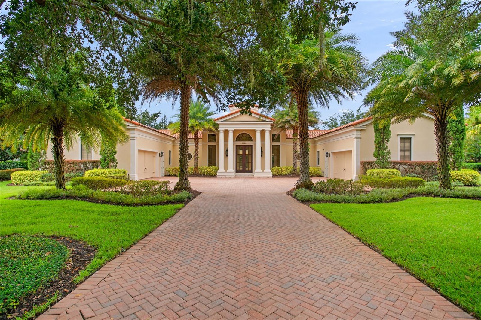 An exceptional estate, masterfully renovated and transformed into a reimagined showplace: complete with a brand-new exquisite chef’s kitchen, family room, and bar with glass enclosed wine rack – plus mammoth private swimming pool and spa with new decking and checkerboard synthetic turf with multiple sitting venues. Featured on CNBC as “most sought-after floor plan,” this masterpiece residence impresses with 30-foot-tall ceilings, tongue and grove with wooden beams overhead, and a wall of windows to greet guests on entry. The spectacular home surrounds the pool area with three bedrooms all ensuite plus den and flex space for a gym in the main residence and a two-story attached building with renovated 4th bedroom or mother-in-law suite and bonus space, offering detached privacy but still within the confines of the residence, connected by breezeway. The family room, bar, and kitchen are all brand new with top-of-the-line Thermador appliances including a Pro Harmony® 48-inch-wide gas range with 6 burners and griddle, built in microwave and oven, refrigerator, double dishwashers, walk-in pantry, island, quartz counters and back splash. The just-completed impressive bar with beverage cooler, wine bottle display, sink and built-in shelving is a showstopper. The distinguished primary retreat and office encompass an entire wing with an oversized bedroom, grand bath with double vanities, jetted tub, tile-enclosed shower, wet bar, walk-in closet, and den with built-in display shelving. A formal dining room is elegantly appointed and perfectly suited for entertaining. For a more casual setting enjoy dining alfresco on the patio with the newly added summer kitchen with louvered pergola off the family room. Expansive grounds take full advantage of the 1-acre lot size. A 4-car garage plus a sizeable paver drive with ample parking affords space for all. Gated Chaine du Lac is known for its generously sized lots and is conveniently located within biking distance to Windermere Elementary. Downtown Windermere offers quaint shopping, an idyllic town hall, monthly food trucks, and weekly Farmer’s Market. Neighborhood also offers easy access to Windermere Prep, Winter Garden Village, the 429, and Florida’s Turnpike.