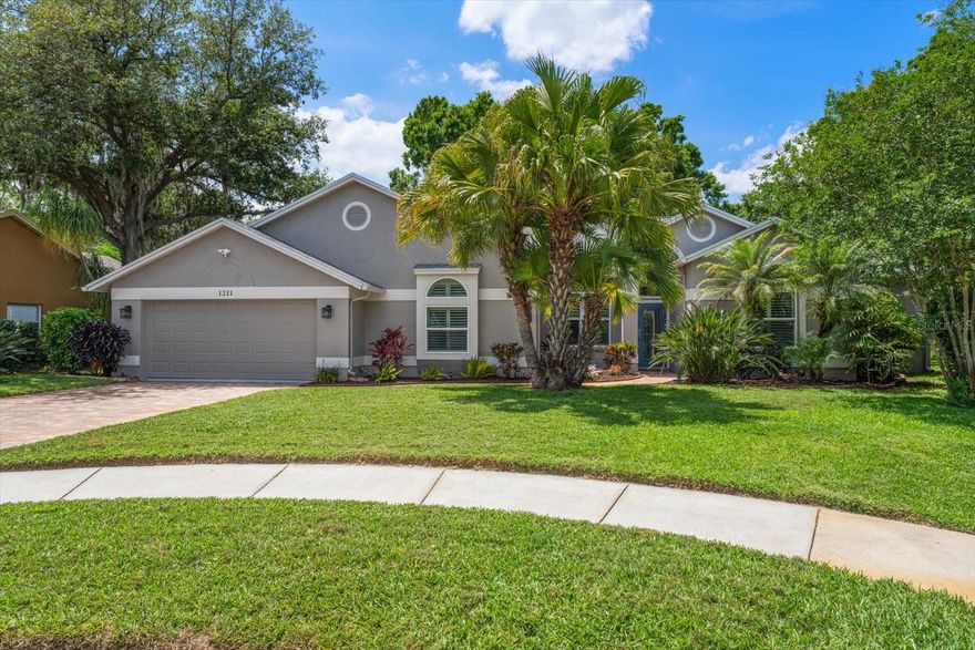 Location, Lifestyle, and Luxury — All in One Stunning Home! Welcome to your dream home—completely updated, meticulously maintained, and truly move-in ready. From the moment you walk in, soaring cathedral ceilings and rich wood floors create a bright, open, and inviting space designed for both comfort and style. Beautiful windows along the back that showcase the tropicallandscaping. Home Highlights: NEW ROOF, Gorgeous plantation shutters and engineered hardwood flooring. All PGT hurricane-rated impact windows and doors for peace of mind. Spacious open floor plan with a large kitchen island—perfect for entertaining and meal prep. Renewed granite fireplace. Inside laundry room with washer and dryer. Enjoy an extra-large primary suite with sitting area and three walk-in closets. The ensuite bath offers a relaxing Tommy Bahama–stylewi th soaking tub and separate shower. Third bedroom includes office suite perfect for those that work at home. Step outside to your oversized screened-in patio, ideal for dining and entertaining, overlooking the lush tropical backyard with ultimate privacy. Situated on a quiet cul-de-sac lot. Bonus Features: Polyaspartic garage floor + extra workshop space, Paver driveway, entry, and decks, Well irrigation system for cost savings, Wired alarm, hardwired Ring camera system, Tool shed on paver decking. Hop on your golf cart and head downtown for year-round festivals or dining at any of the Great local eateries—this home truly delivers location,
lifestyle, and convenience. Nothing to do but move in and relax.