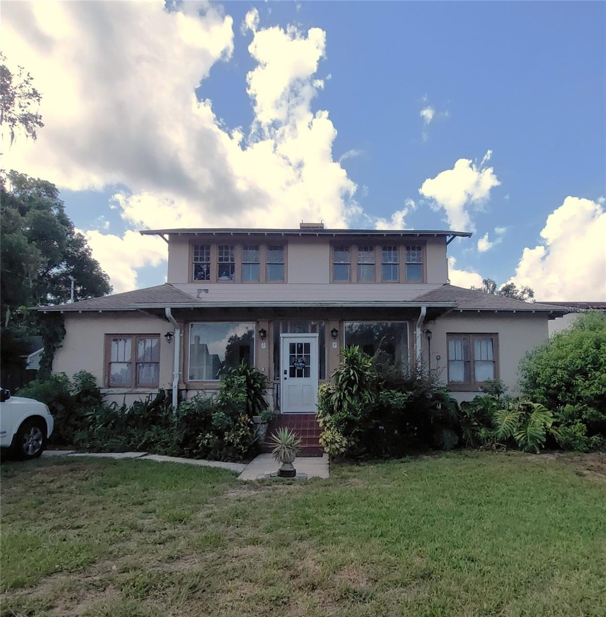 This property is located near downtown Eustis within the city limits. Four bedroom, two full bath home built in 1919. Primary bedroom, bathroom and second bedroom on the first floor, while the two other bedrooms and a bathroom are upstairs. Large enclosed front porch. Nice foyer/study with a fireplace as you enter the home. Dining room with two entries. Half basement with crawlspace. Large living room area with an open area/sun room behind the living room. Utility room/mud room has the gas clothes washer and dryer that connects to both the sun room and kitchen. Current owner has completed some interior work and is giving the opportunity for new owner(s) to put their interior decorating skills to practical use. Privacy fence installed with driveway partially enclosed. Detached garage located in the rear of the home inside the privacy fence. Home Warranty through American Home Shield.