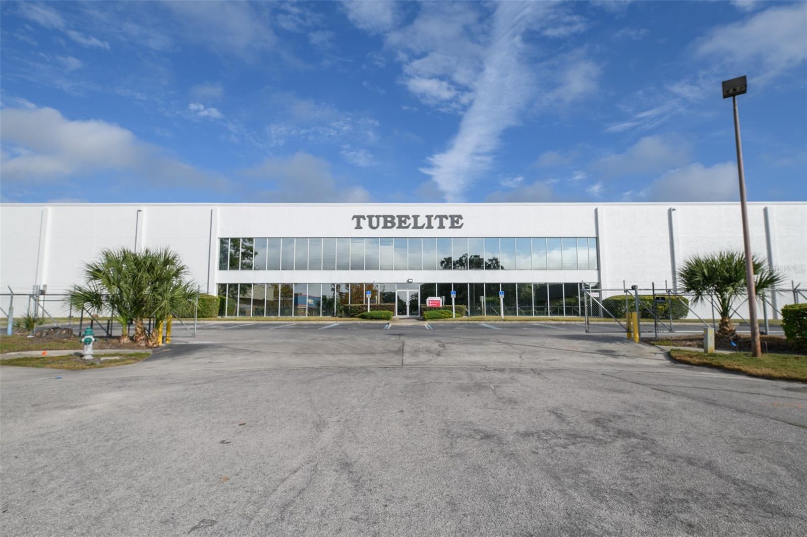 Prime commercial property in Apopka featuring a spacious 55,000 sqft building on 5 acres. This versatile space includes a well-designed split of 45,000 sqft for warehouse use and 10,000 sqft spanning two floors for office spaces. The property boasts numerous amenities, including multiple offices, bathrooms, break rooms, and training rooms. It comes with a brand new roof, ensuring durability. With ample parking and outdoor storage, this property offers convenience and flexibility. Security is a top priority with a complete security system in place. Other highlights include multiple docks, a full generator, and a robust fire suppression system. Exceptionally well-maintained, this commercial space is ready for various business needs.