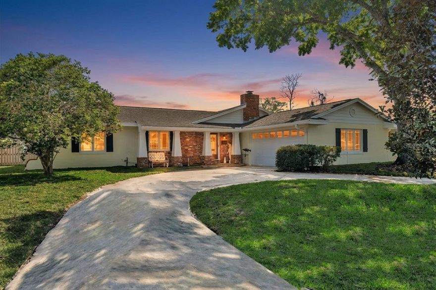 One or more photo(s) has been virtually staged. Set on one of the most sought-after streets in Dommerich, this completely renovated home combines the solid construction of a 1963 block home with thoughtful modern updates throughout. From the moment you arrive, the circular driveway, classic brick accents, and welcoming front porch set the tone. Inside, a bright foyer opens to beautiful solid maple wood floors and a light, airy feel that carries throughout the home. To the right, the formal living room features built-in shelving and a striking brick wood-burning fireplace, while the adjoining formal dining room connects directly to the kitchen and can be closed off with pocket doors if you want a little separation. The eat-in kitchen is truly the heart of the home, showcasing rich solid cherry cabinetry, unique man-made glass countertops, a large farmhouse sink, and top-of-the-line stainless Bosch appliances including a built-in oven and gas cooktop. A generous peninsula overlooks the oversized family room, where French doors open to a stunning Florida room that fills the home with natural light. This space is a showstopper—large, lined with windows, and finished with soaring shiplap ceilings—creating the kind of room you’ll use year-round, with direct access to the backyard. The primary suite is spacious and refined with crown molding, a built-in closet plus a walk-in, and a beautifully renovated bath featuring matching glass countertops, a Kohler vanity, and a glass shower with both a large rain head and handheld fixture. Two additional bedrooms are generously sized and share an updated hall bath with a large vanity, classic subway tile, and a soaking tub. The interior also includes a well-equipped laundry room with cabinetry, a cedar storage closet, and access to the two-car garage. Out back, the fully fenced private yard offers plenty of room for entertainment, recently re-sodded with irrigation and enclosed with a brand new wood fence installed in 2025—leaving ample space for a future pool or patio if desired. Additional upgrades include smooth flat ceilings with recessed lighting throughout, new drywall, plantation shutters, updated windows and doors, and an energy-efficient hybrid water heater. Beyond the home itself, the location is hard to beat—just a short walk to Dommerich Elementary, Maitland Middle School, and Maitland Community Park offering tennis courts, indoor racquetball, and playgrounds. Zoned for highly regarded Winter Park High School. Call today to schedule your private showing!