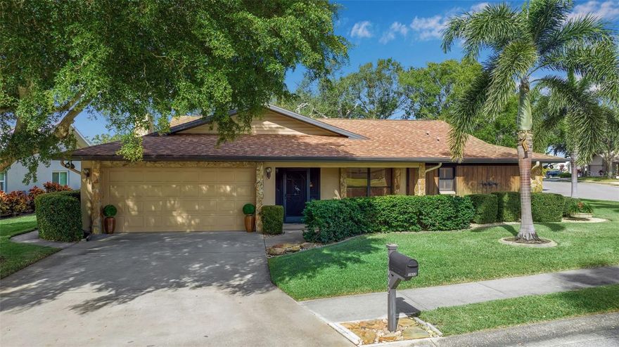 Meticulously maintained 3-bedroom, 2-bath home situated on a pond-front corner lot in the desirable Indian Springs community of NW Bradenton. Originally the model home, this property makes a strong first impression as you enter the neighborhood, featuring a covered front porch and inviting foyer.


The split floor plan offers privacy and functionality, with an open-concept living area that includes vaulted ceilings and a fireplace. The kitchen features granite countertops, a serving window to the lanai, and flows seamlessly into the main living space, making it ideal for everyday living and entertaining.


The spacious lanai has been enclosed and includes air conditioning, providing additional year-round living space. The primary bedroom offers direct access to the lanai through sliding glass doors, double closets with one walk-in, and an ensuite bath featuring a vanity area and walk-in shower. Secondary bedrooms include built-in storage, and the guest bathroom offers a tub/shower combination with a granite countertop.


Additional features include an indoor laundry room with utility sink, Bahama shutters on select windows, and a pond-side retaining wall that was professionally treated with seawall and bulkhead soil stabilization injections in September 2025.


Located in NW Bradenton, this home offers convenient access to local beaches, parks, and recreation, including Anna Maria Island, Robinson Preserve, GT Bray Park, and IMG Academy, along with nearby shopping, dining, and everyday conveniences.