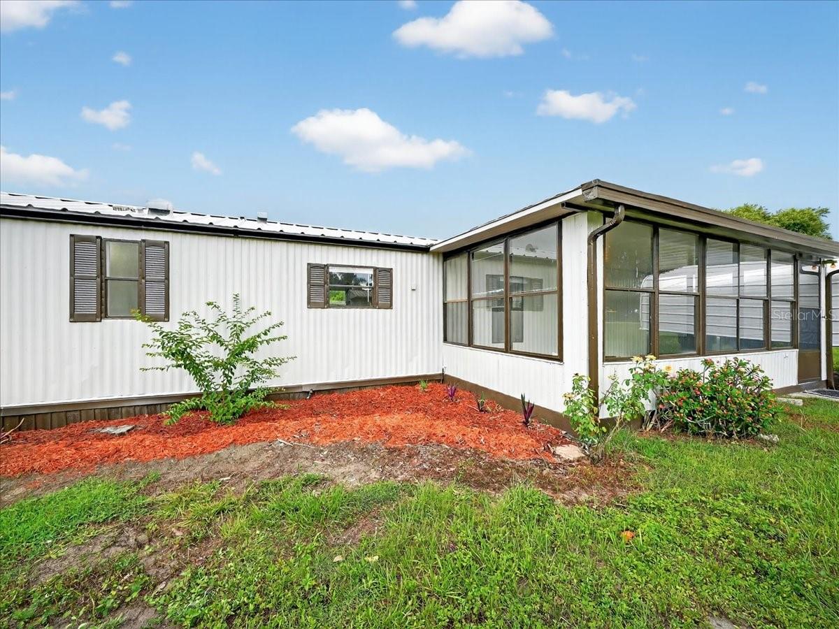 MOTIVATED SELLER! OWNED LAND. This beautifuly renovated home offers privacy, serenity, and a connection to nature, look no further! Nestled on a spacious 14,280 sq. ft. lot with two parcels of *Owned Land* totaling .63 ACRE and No HOA/CDD, this beautifully renovated 1993 Fleetwood-built manufactured home in the Little Red Water Lake subdivision offers the perfect blend of comfort and functionality. This 2-bedroom, 2-bath split-plan home has been thoughtfully upgraded for modern living. Recent improvements include: Brand New HVAC System, New Well & Plumbing, New Gas Tank, Updated Ceramic Tile in the Florida Room and Refreshed Back Porch.
The enclosed 10’ x 20’ front porch provides a relaxing space to enjoy the quiet surroundings. The lot features two sheds and two carports, giving you ample storage and parking space. Inside, you'll find a spacious living room, a combined kitchen/dining area, and a split bedroom layout for added privacy—perfect for guests or family. The primary suite features an en-suite bath, and there's a dedicated laundry area with a new custom pantry. This home has only been used as a seasonal retreat and is now move-in ready for year-round enjoyment. This quiet neighborhood also includes private boat ramp access to Little Red Water Lake. This home is not located in a park.
-