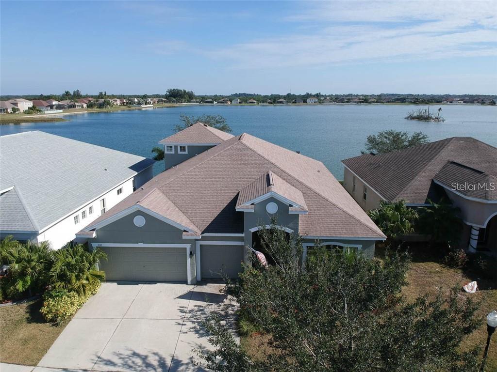 Furnished Rental. Will cover utilities and WIFI for additional fee.This is a gorgeous 4 bedroom, 3 bathroom, 3 car garage, WATERFRONT home in the GATED community of Mira Lago waiting for its new owners. This home is move in ready and has been recently UPDATED with new floors, fresh interior/exterior paint, and a LARGE, BEAUTIFUL LANAI area that has 60 feet of lakefront on a 65 acre lake. Sunrises in the morning and shade to keep you cool in the afternoon. As you enter the home, there is a large front room and a grand entryway. The living space of the home is open and inviting. This tasteful kitchen features travertine floors, corian counter tops, stainless steel appliances, a closet pantry, breakfast bar, and brand new island with gorgeous granite countertop. There is a dining nook in the kitchen with wainscot walls and updated lighting. All ceiling fans have been replaced within the past year. The laundry room is conveniently off the kitchen and has extra storage. The master bedroom and 4th bedroom both sit at the back of the house with their own private bathrooms. The master bedroom has his and her closets, double sinks, a garden tu, brand new lights, and a separate toilet room. Bedrooms 2 and 3 share a full bathroom. The large, upstairs bonus room can be used as an office, bedroom, man cave, play room, or media room and also has great LAKE VIEWS.The lanai area is HUGE and features an outdoor CUSTOM WOOD BURNING FIREPLACE and gorgeous views of the lake. Enjoy your evening meal here each day. Mira Lago is a well kept, safe, friendly community minutes to Tampa, St. Pete, Manatee County, area beaches, and many other amenities. The community has a heated pool, plenty of lakes/ ponds with fountains, basketball court and playground.