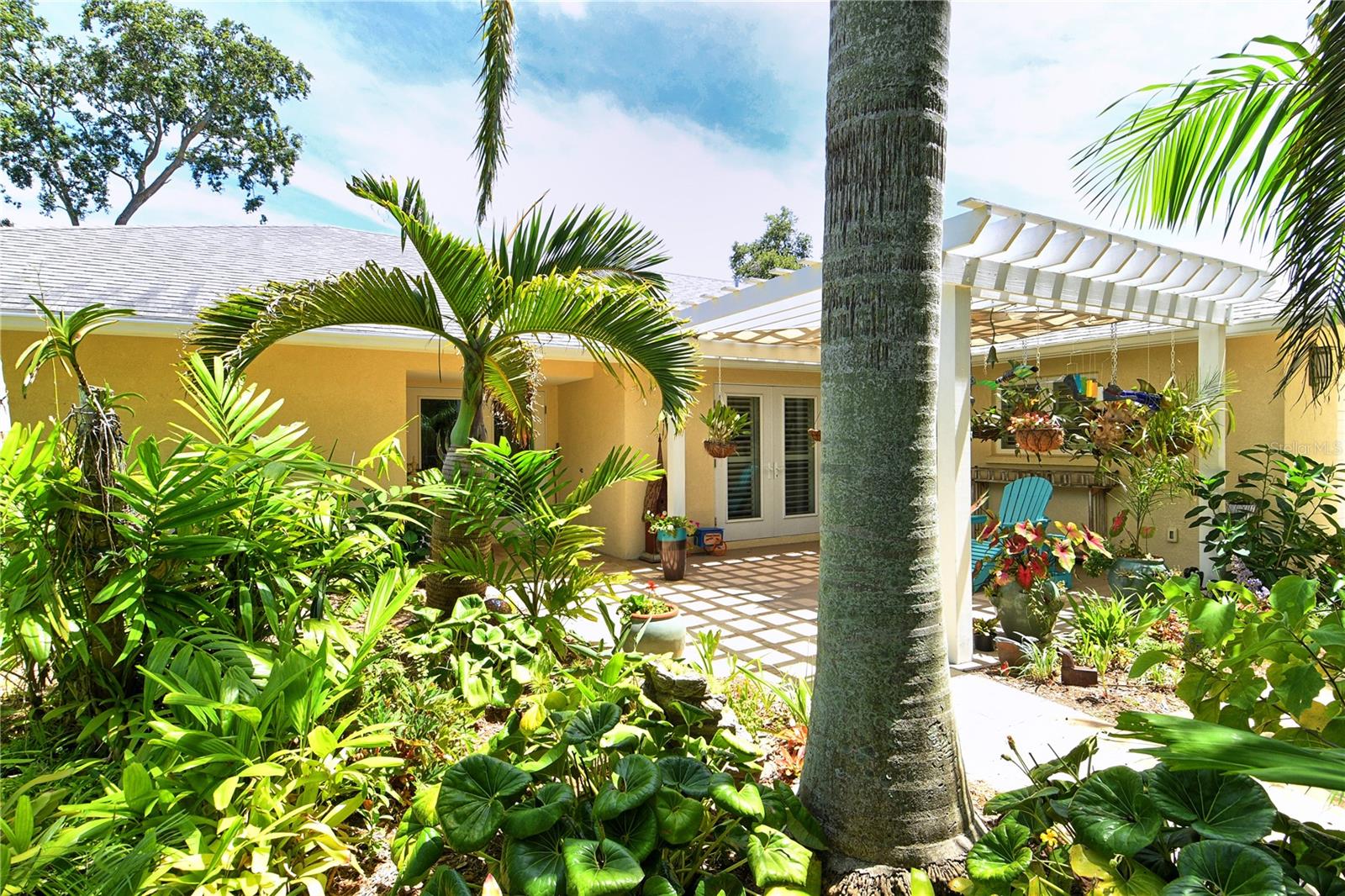 Only rarely will you find a home in NW Bradenton like this gem! Sitting high and dry with all hurricane impact windows and doors, you’ll be able to relax and rest easy here. No expense was spared in its total customization in 2013, and it has been lovingly maintained and continuously upgraded ever since. As soon as you step into the lushly landscaped front yard, the street and the neighbors disappear, and you feel enveloped in a verdant oasis of privacy and quiet. Survey it all from your shaded front patio before passing through the glass front doors into the spacious foyer, and beyond to the dining area. French doors line the walls of the main living space with natural light, and at the center of it all you’ll find a gourmet kitchen with twin islands and sleek custom cabinetry wrapping around appliances from SubZero, Wolf, and Fisher-Pykel. All of this looks out onto the inviting solar-heated pool with plenty of shaded lounging area and a refreshment center. Off the kitchen is a walk-in pantry and laundry area with storage behind touch-open cabinet doors. Everywhere you look you will find the subtle details of a very particular and painstaking renovation process, including a smart triple split bedroom/bath floorplan and custom plantation shutters on every window. Unique features include a huge artist studio/4th bedroom (11 x 26) with built-in cabinetry that could put to any number of uses by the imaginative buyer, including being easily converted back into two separate rooms (which would bring the total to 5 bedrooms). That whole wing with pocket door is served by its own luxurious pool bath. Each of the three bathrooms is a masterpiece of tile, granite and cabinetry, and the owners’ walk-in closet is full of custom shelving and hanging storage. Out in the garage you’ll find another unique feature: one parking space is a discreet air-conditioned extra room (9 x 19) that can be used for storage, a home office, or hobby room. If you’d prefer to have the second garage space, it’s a simple project to return it to its original configuration. Belair Bayou HOA is an enclave of 59 homes with low fees and minimal deed restrictions that does NOT allow short-term rentals, so the neighborhood maintains its quiet residential character. Whatever you're in the mood for, you are in a great central location: In just minutes, you can take in the gorgeous Gulf beaches and the resort villages of Anna Maria Island. Just around the corner is the Warner's Bayou boat ramp facility with easy access to the Manatee River and the Gulf beyond. Plus, you're just a few miles from Robinson Preserve, a choice destination for hiking/biking/kayaking and near the Palma Sola Botanical Park and DeSoto National Park. There is so much to love about this versatile home, so come see it – and make it yours.