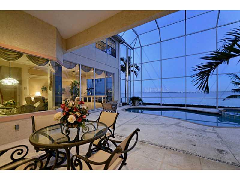 Sprawling WRAP-AROUND BAYFRONT HOME with EAST AND SOUTHERN EXPOSURE! Custom built, tropical haven on 259 feet of sailboat water. Dock and lift will accommodate a very large yacht. Sweeping views of Sarasota Bay & unobstructed views of Downtown Sarasota.Superbly detailed, elegantly appointed 3BD/3BA + exercise room and office downstairs with a bonus play/game room upstairs is stately living at its finest! Gourmet kitchen with top of the line appliances. Enjoy your breakfast from the dining nook with expansive aquarium windows. Walls of glass throughout invite you to enjoy bird watching, sunrise and dolphins at play. The fabulous master suite is downstairs and offers dramatic views of the Bay. The master bath has a roman tub & separate shower. All bedrooms are En-suite. Luxury knows no limits at this crafted residence. Double door big boy toy room under house for fishing & boating equipment, with loft for additional storage! Lush landscaping sitting on private cul-de-sac. This home is perfect for the buyer in search of the ultimate Florida lifestyle. Located just minutes away from the cultural, social and entertainment hub of downtown Sarasota, the Sarasota/Bradenton Airport, & St. Armand's elite shopping area. Country Club Shores has beach access north of LBK Islandside golf course and south of Beachplace. This community of single-family homes is set on 19 streets, each with distinctive nautical or golf-related names and remains one of Longboat Key's most prestigious addresses.