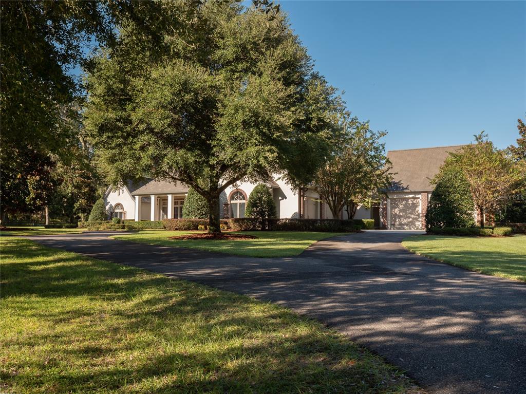 Located in deep in the heart of NW Ocala's horse country, less than 10 minutes to the World Equestrian Center, is this gorgeous 21+ acre European Country estate. The elegant custom home spares no details, and features hardwood floors, travertine, crown moldings, beamed ceiling, and tons of large windows providing beautiful views of the pastures beyond. The chef's kitchen goes above and beyond in functionality and beauty, and would satisfy the tastes of the most discerning chef. The stunning master suite opens to the back patio, and you'll never want to leave the luxurious bath. This farm provides a gated entrance and beautifully maintained board-fencing throughout. There are 8 lush green paddocks, round pen, and a WordleyMartin irrigated arena. The barn emulates the design of the home, and features 10 European-designed custom stalls, studio apartment with full bath and walk-in closet, office/tack room with 1/2 bath, laundry, fly spray, and plenty of storage. There are 3 run-in sheds in the paddocks, providing 3 additional stalls. This farm is meticulously maintained and ready for you and your horses to enjoy.