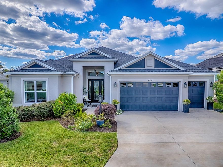 SPECTACULAR GOLF COURSE and WATER VIEW on this CUSTOM “10” HOME COMPARABLE to the EGRET PREMIER plan offering 10 ft. CEILINGS and 8 ft DOORS throughout! Located in the popular enclave known as “Little DeLuna” surrounded with beautiful premier and designer homes and positioned on hole 4 of the Lowlands Executive Golf Course with plenty of room for a POOL!  This LOVELY home has so much to offer from the STUNNING LEADED GLASS front door with sidelites to the 12 x 46 lanai encompassing the entire width of the home accessible through STACKABLE SLIDING GLASS DOORS! WOOD LOOK PORCELAIN TILE flooring runs throughout the home. The amazing kitchen has mossy gray cabinetry, a unique but very neutral color, enhanced with an impressive matte black and champagne bronze hardware. Other kitchen features include custom windows offering more natural lighting, HERRINGBONE-GLAZED tile backsplash, WATERFALL GRANITE island, GAS COOKTOP with vent hood, and DOUBLE OVENS. Impeccable features throughout includes custom ARCHITECTURAL walls, exceptional enhanced lighting, remote controlled blinds, granite in both baths, solar tube, and the list goes on. The spacious 745 sf garage with golf cart garage has a ceiling fan, epoxy flooring, and plenty of room for all your needs!  Located minutes away from Hogeye Preserve walking path, Water Lily Recreation Center, Everglades Recreation Center, Magnolia Plaza, Ednas on the Green, Brownwood Square, Sawgrass and Eastport! This truly is a great location! THIS IS AN AMAZING HOME WITH ONE OF THE BESTS VIEWS YOU’LL FIND IN THE VILLAGES!