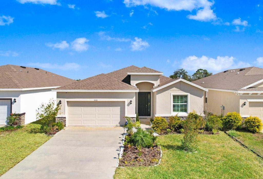 Don't wait to build! MOVE-IN READY! ***This meticulously maintained home, boasting 4 bedrooms and 2.5 baths on a captivating conservation lot, provides a serene backdrop for everyday living. The highly desired open floor plan (Lantana) bathes the living spaces in natural light as you enter, creating a warm and welcoming atmosphere. The gourmet kitchen offers sleek countertops, stainless steel appliances, and a generous pantry, seamlessly flowing into the spacious living area—an ideal space for entertaining and everyday family life. Plantation shutters in all bedrooms added. Upgraded refrigerator, washer and dryer included a $10,000.00 value. The owner's suite offers a generous layout, with his and hers walk-in closets and a spa-like ensuite bathroom with a soaking tub and a separate walk-in shower. Three additional bedrooms provide comfortable accommodations for family members or guests, while the extra half bath adds convenience to your daily routine. Step outside to the covered lanai and discover your private oasis. The beautifully landscaped backyard, set against a conservation backdrop, invites you to relax, unwind, and savor the tranquility of your surroundings. Perfect for outdoor gatherings or a quiet retreat after a long day. It is just a few steps from the community pool. Situated in a sought-after neighborhood, this home is a tranquil retreat close to local amenities, shopping centers, and hospitals. With easy access to major highways, the pristine beaches of the Gulf Coast and the vibrant cultural scene of downtown Bradenton are just a short drive away. Don't miss this opportunity! Contact us to schedule a showing. Make 4013 Lively Coral Pl your home, where the perfect blend of comfort, elegance, and natural beauty awaits. Schedule a showing today and experience the lifestyle that this Bradenton gem has to offer.