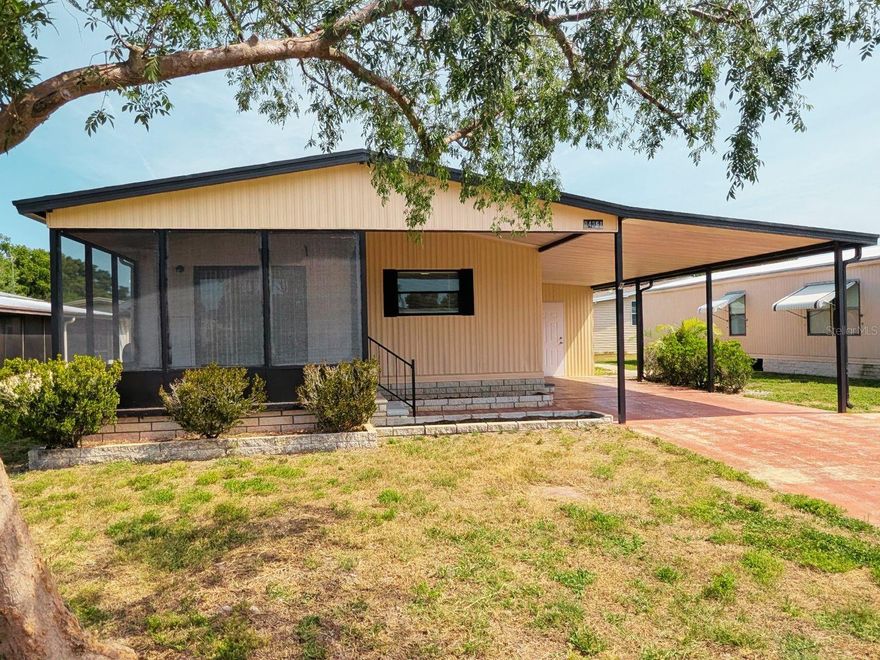 Practical Living in Wesley Chapel! Discover this nicely renovated home nestled within the gated, all-ages community of Timber Lake Estates. Your reasonable monthly Condo/HOA Fee includes lawn maintenance, water, sewar, and trash pick-up! No detail was overlooked in this transformation, offering a turnkey lifestyle for the most discerning buyer. The open-concept interior impresses immediately with vaulted ceilings and an abundance of natural light. The kitchen is a showstopper, featuring a stainless steel Frigidaire Professional refrigerator, stylish grey cabinetry with modern hardware, and beautiful countertops. Retreat to the primary suite or guest bedrooms, all featuring consistent modern flooring and fresh, neutral paint. The bathrooms have been fully reimagined with custom floor-to-ceiling tile work, contemporary vanities, and updated fixtures. Exterior & Bonus Features: Massive Workshop/Storage: An oversized, insulated detached building with a wall AC unit and laundry hookups, perfect for a "man cave", hobby room, or climate-controlled storage.
Outdoor Living: Relax on the expansive screened-in front porch or utilize the deep, covered carport. Peace of Mind: Located in a secure gated community with excellent proximity to The Grove, KRATE, and easy I-75 access. This isn't just a home; it's a lifestyle upgrade. Schedule your showing today and see the quality for yourself!