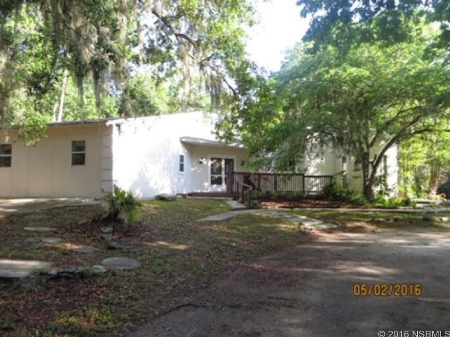 3BR/3BA unique designed block home in New Smyrna Beach! Large formal living room and dining room. New kitchen with maple cabinets and granite countertops, and an island with seating. Very open floor plan with lots of natural light. Two master suites. Inside laundry and screened porch overlooking quiet pond. Out buildings for storage. Very private, rural, feel right in the middle of town. Convenient location to shopping, minutes from the beach and I-95.All information taken from the tax roll and deemed reliable but not guaranteed. ;Water: City