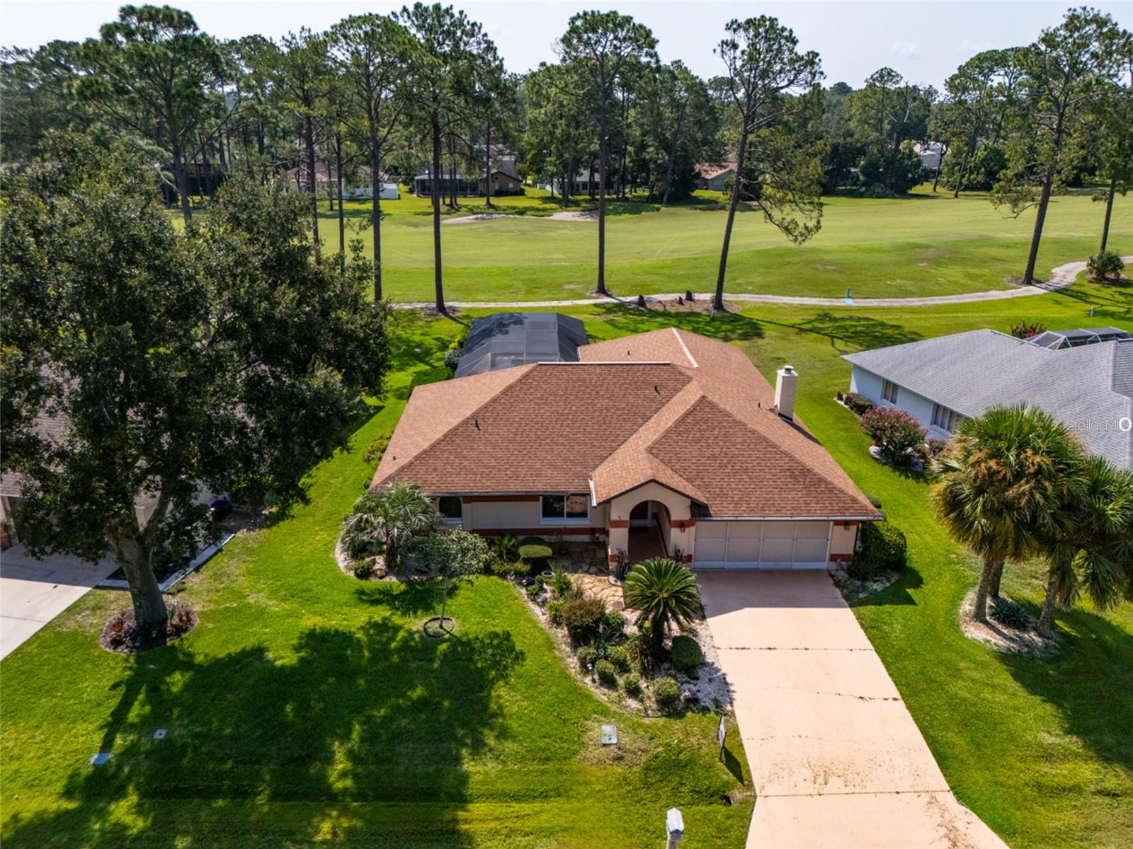 Beautiful 4 bedroom, 3.5 bath POOL home located directly on the Pine Lakes Golf Course in the desirable “W” section of Palm Coast. This well-maintained home features real wood floors in the living areas, a cozy brick fireplace, and a spacious kitchen with upgraded cherry cabinets, JennAir cooktop & oven, stainless-steel appliances, including a wine fridge, and a butcher block movable island with plenty of storage. The split floor plan offers a private master suite with a large walk-in closet, an elegant vanity with double sinks, a whirlpool tub, a separate shower, and sliding doors out to the pool. One guest bedroom has its own en-suite bath, perfect for guests or in-laws. The home has updated windows and sliders, hurricane shutters, and a central vacuum system. AC has a built-in air scrubbing system. Step outside to enjoy a covered and screened lanai overlooking the resurfaced 40’ x 9.5’ lap pool and golf course views. Ideal for entertaining or relaxing Florida-style! This home can be sold completely furnished. Home has a very successful history as an Airbnb. Documents provided upon request.