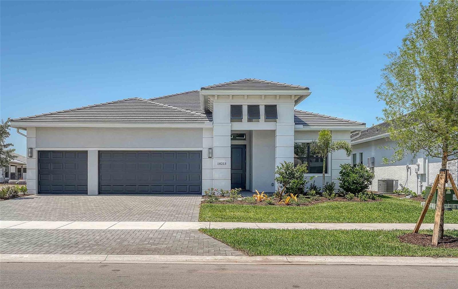 ***NEW CONSTRUCTION*** Step into modern elegance with this beautifully crafted Alys Model residence, offering 3 bedrooms, 3 bathrooms, and a dedicated den/office space. With a coastal-modern aesthetic, clean lines, and thoughtful design, this home boasts a spacious 3-car garage and an open-concept great room, perfect for both entertaining and relaxation. Enjoy tranquil wetland views from your great room, complemented by a sleek kitchen equipped with luxury Café appliances to inspire your culinary creations. Outside, your covered lanai is designed for seamless outdoor living with built-in utilities for a future summer kitchen—ideal for hosting or just enjoying serene moments. Located within the award-winning Lakewood Ranch community, this home embodies effortless living with access to an all-inclusive lifestyle.