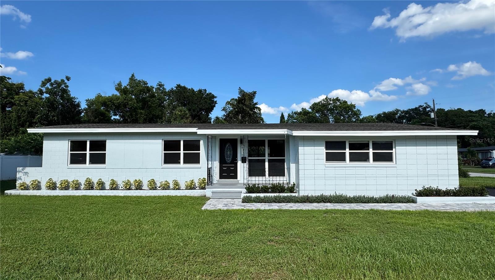 Downtown is just a few miles away. Welcome to this beautifully renovated 3-bedroom, 2-bathroom home with an oversized 2-car garage, roof 2022, perfectly situated on a spacious corner lot. This move-in-ready property boasts stunning curb appeal with fresh exterior paint, modern landscaping, and a wide paver walkway leading to a charming covered front porch. Inside, you’ll find a bright, open-concept layout featuring original refinished hardwood floors, complete rewire, a fully updated kitchen with sleek gray shaker cabinets, granite countertops, stainless steel appliances, and an oversized center island perfect for entertaining. Both bathrooms have been tastefully remodeled with contemporary finishes, while large windows fill the home with natural light. Additional highlights include fresh interior paint, upgraded lighting, and a freshly painted garage. This home blends modern upgrades with timeless charm. Conveniently located near shopping, dining, schools, parks, walking trails and major highways like 436, SR 408, I-4, —TOP-RATED SCHOOLS - LAKE COMO K-8 and BOONE HIGH!